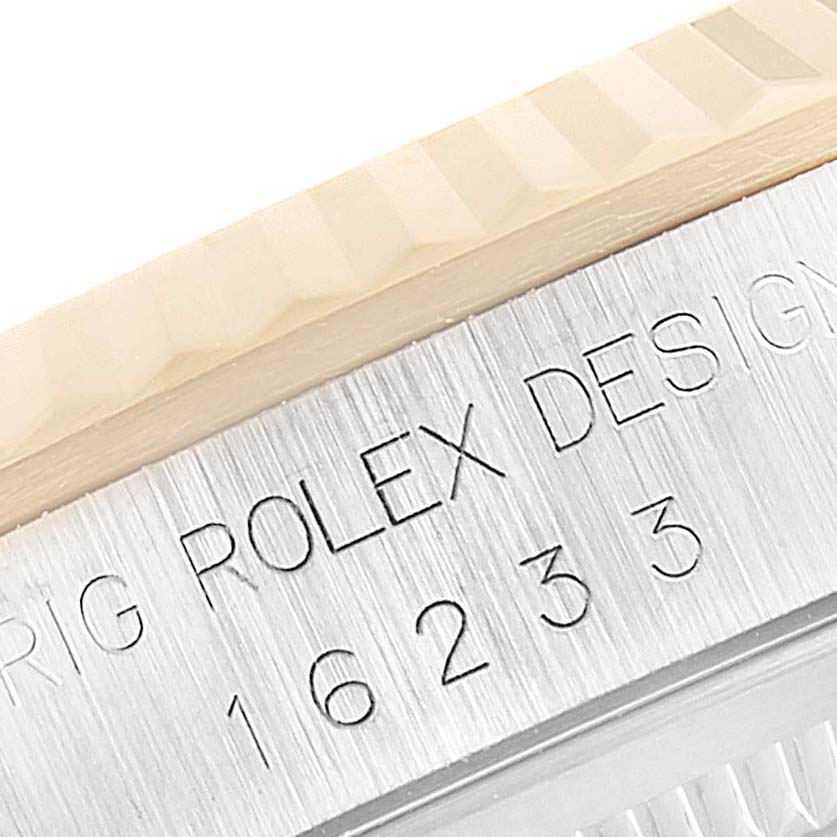 This close-up image shows the side engraving and part of the bezel on a Rolex Datejust 16233 Men
s Steel and Gold (two tone) Grey Dial 16233 Men
s Steel and Gold (two tone) Grey Dial watch.