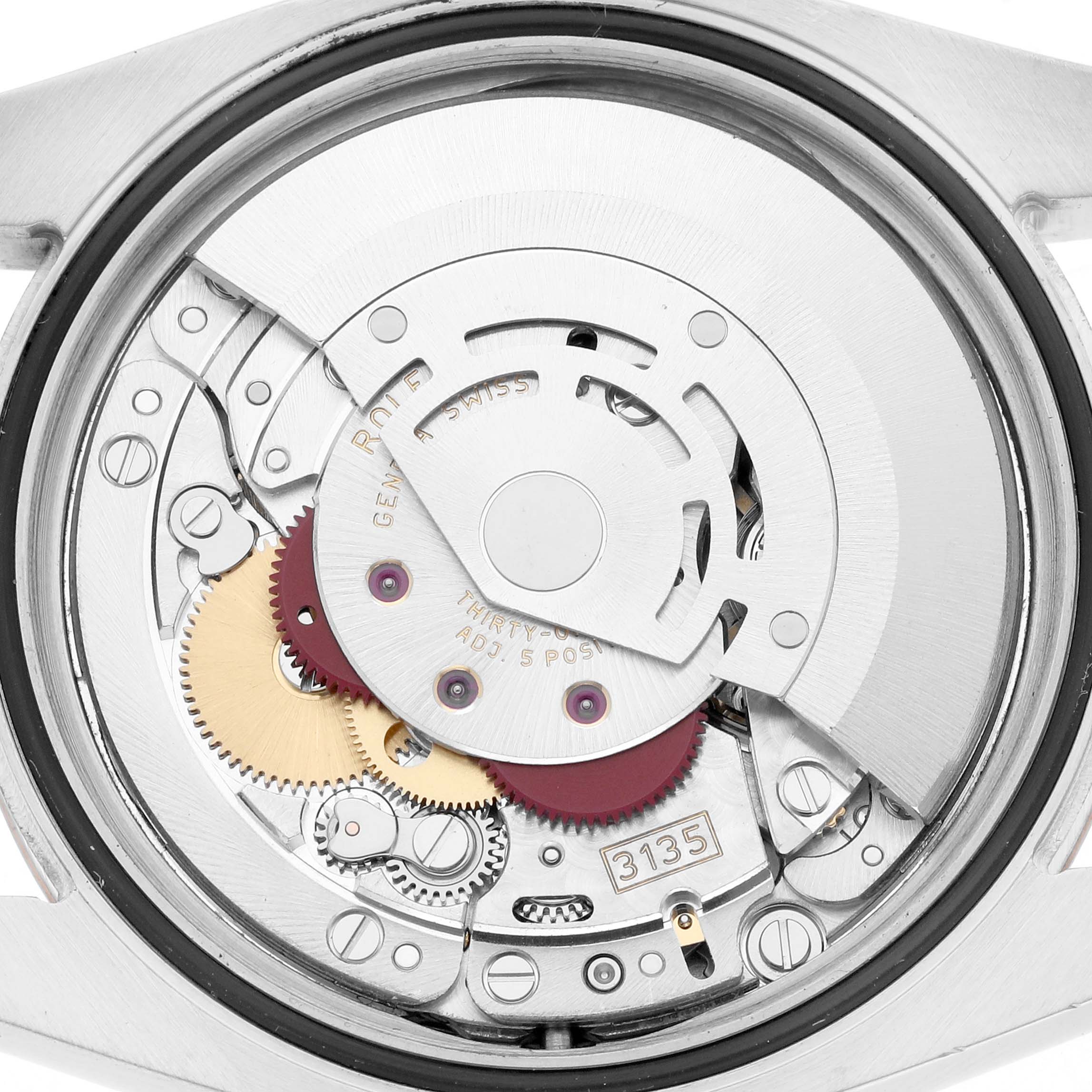 The image shows the exposed movement of a Rolex Datejust 116231 Men
s Steel and Gold (two tone) Pink Dial, displaying its intricate gears and components.