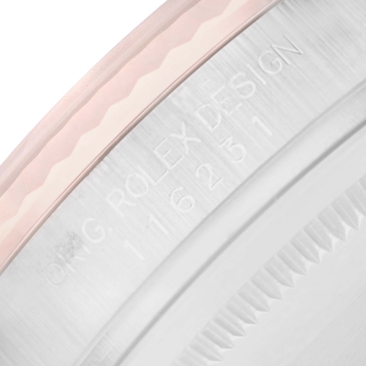 The image shows a close-up of a partial bezel and case edge of a Rolex Datejust 116231 Men
s Steel and Gold (two tone) Pink Dial watch, highlighting engraved details.