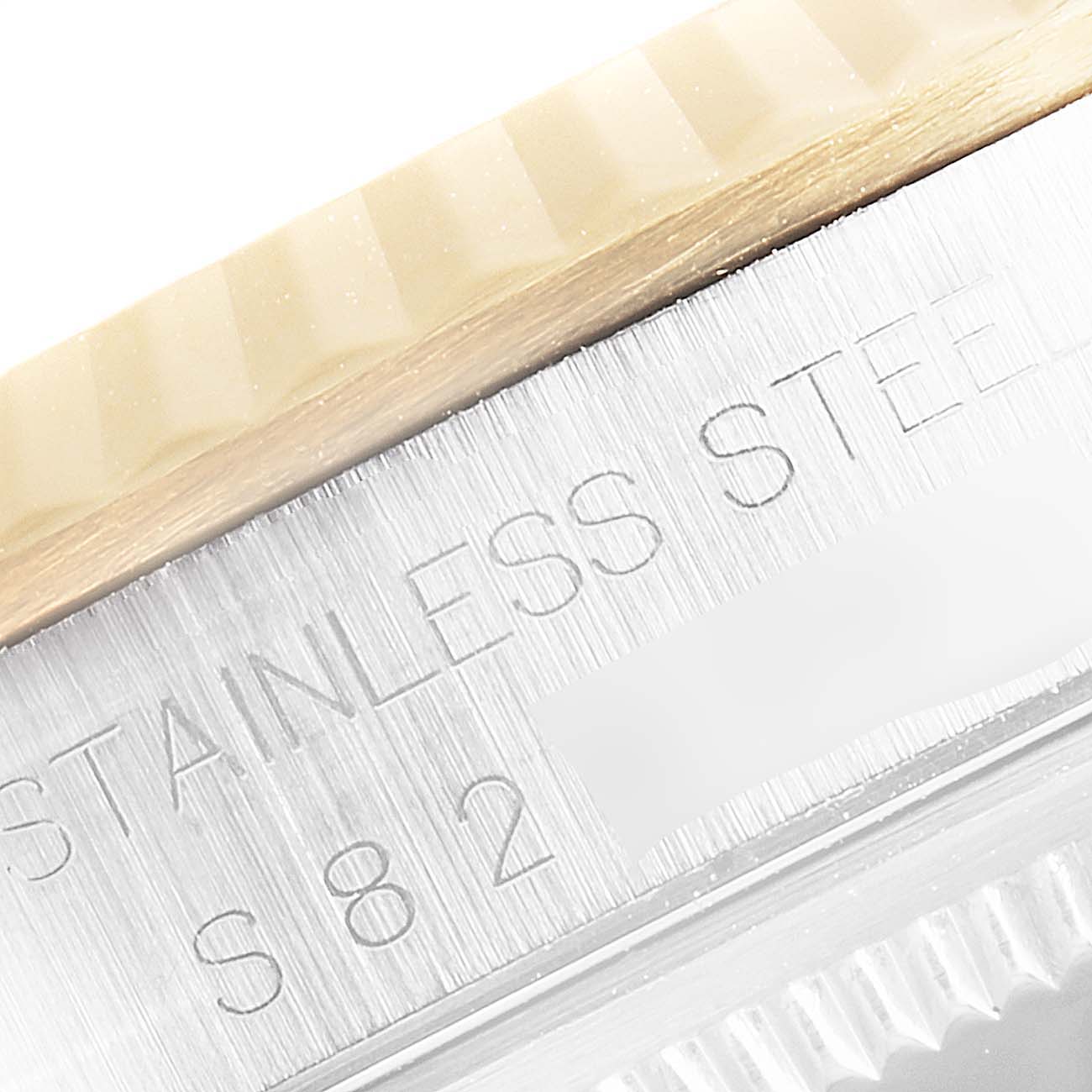 Close-up of the edge of a Rolex Datejust 16233 Men's Steel and Gold (two tone) Black Dial 16233 Men's Steel and Gold (two tone) Black Dial watch, showing part of the bezel and the stainless steel case.