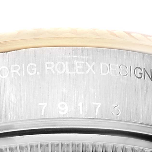 The image shows a close-up of the serial number engraving on the case side of a Rolex Datejust 79173 Women's Steel and Gold (two tone) Champagne Dial 79173 Women's Steel and Gold (two tone) Champagne Dial watch.