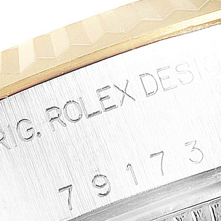 This image shows a close-up of the bezel and engraved serial number of a Rolex Datejust 79173 Women's Stainless Steel Champagne Dial 79173 Women's Stainless Steel Champagne Dial watch.