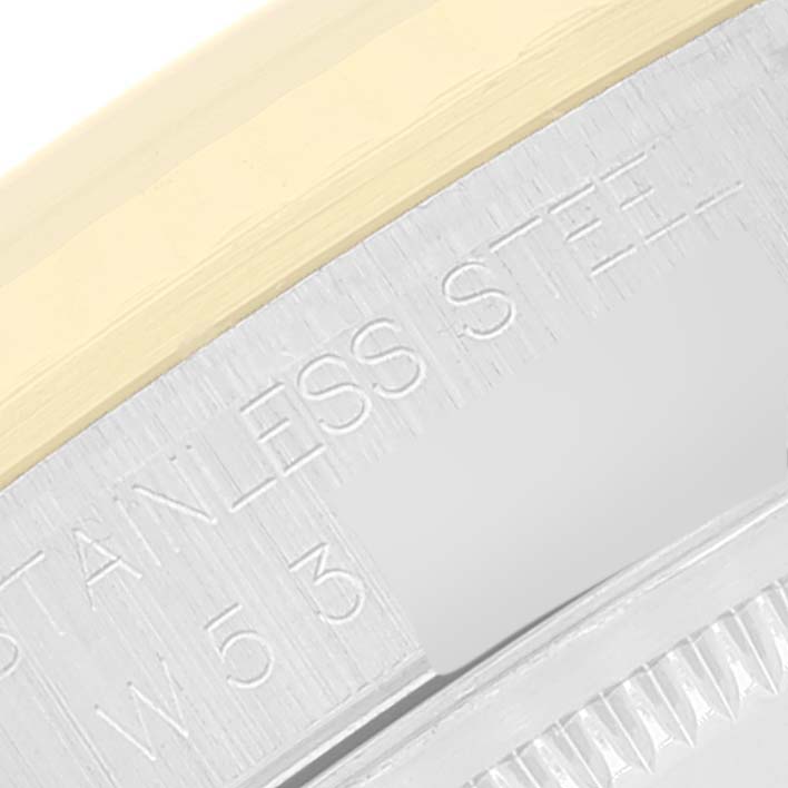 The image shows a close-up of the Datejust Rolex watch's stainless steel engravings on the case.
