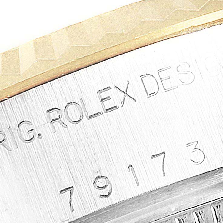 The image shows an engraved part of the Rolex Datejust 79173 Women's Stainless Steel Silver Dial 79173 Women's Stainless Steel Silver Dial model, including the bezel and casing.