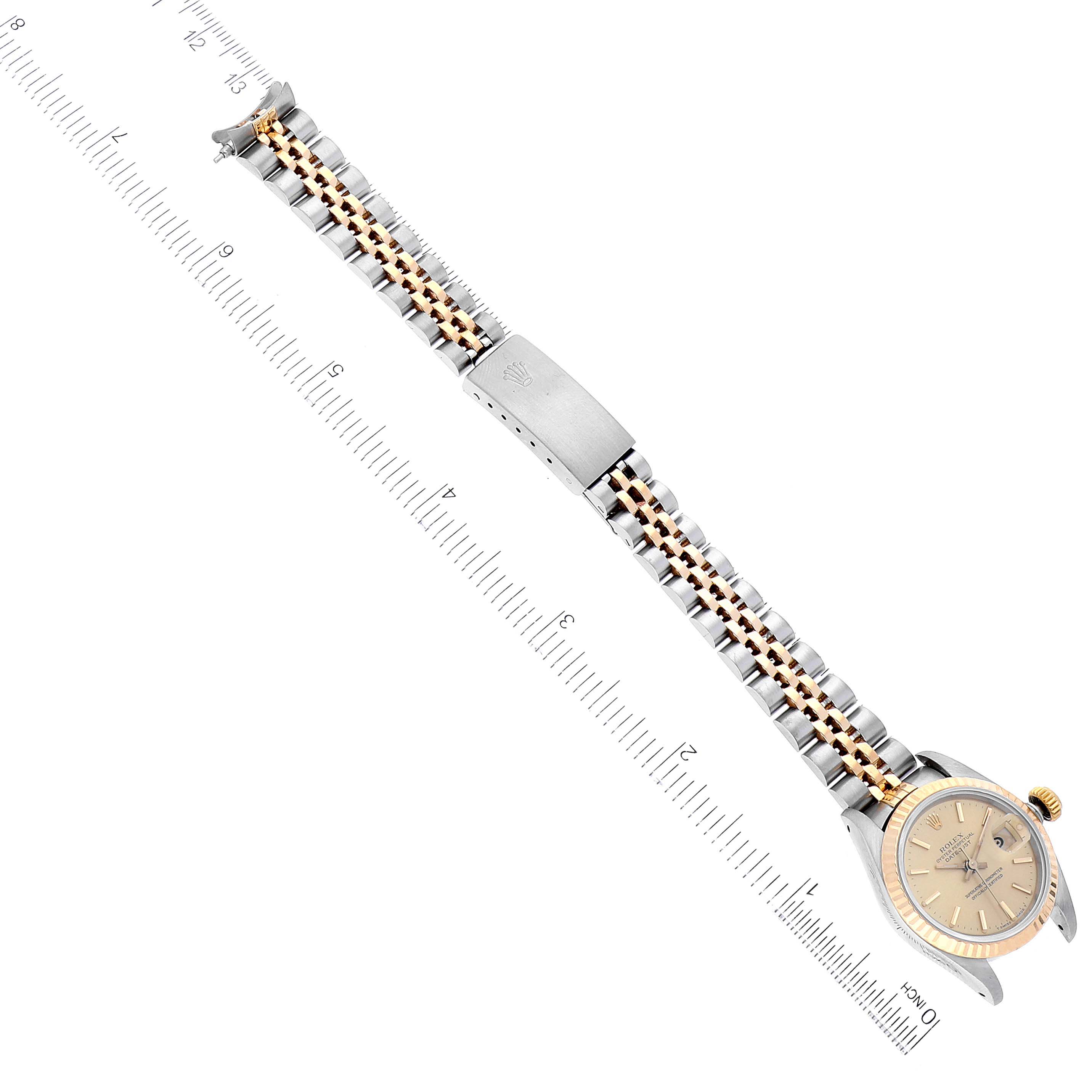 The image shows a Rolex Datejust 69173 Women's Steel and Gold (two tone) Champagne Dial 69173 Women's Steel and Gold (two tone) Champagne Dial watch from a top-down angle, displaying the full length of the bracelet, clasp, and watch face.