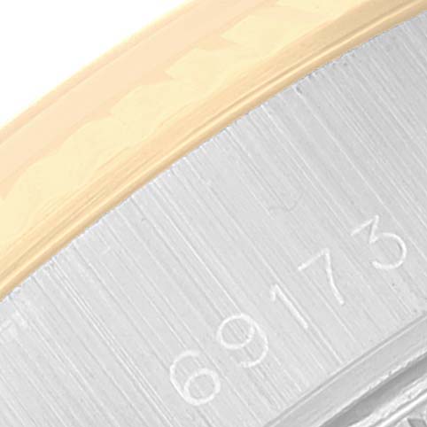 This image shows a close-up of the serial number and a portion of the bezel of a Rolex Datejust 69173 Women's Steel and Gold (two tone) Champagne Dial 69173 Women's Steel and Gold (two tone) Champagne Dial watch.