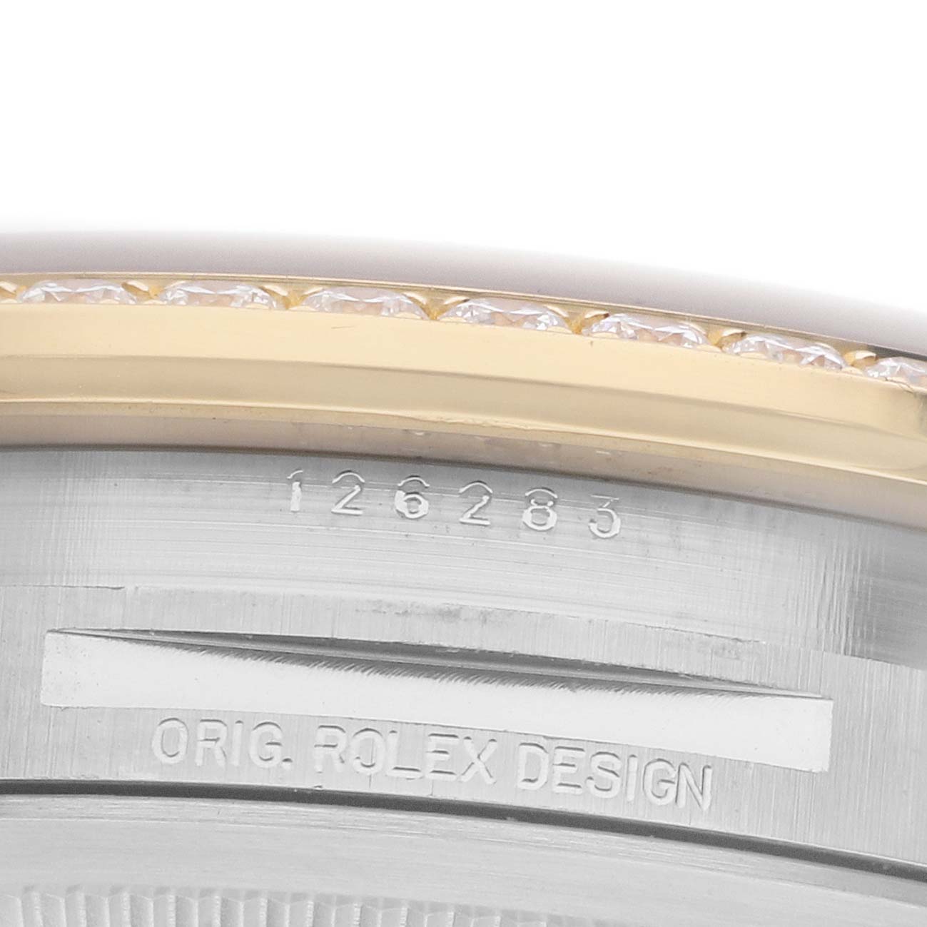 The image shows the side of the Rolex Datejust 126283 Men's Steel and Gold (two tone) Mother of Pearl Dial model, highlighting the serial number and part of the diamond bezel.