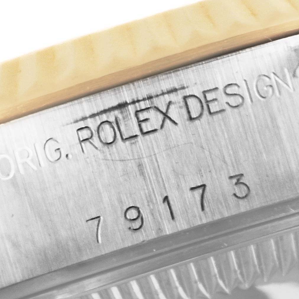 This image shows a close-up of the side case and edge of the bezel of a Rolex Datejust 79173 Women's Steel and Gold (two tone) Mother of Pearl Dial 79173 Women's Steel and Gold (two tone) Mother of Pearl Dial watch, displaying the model number and branding.