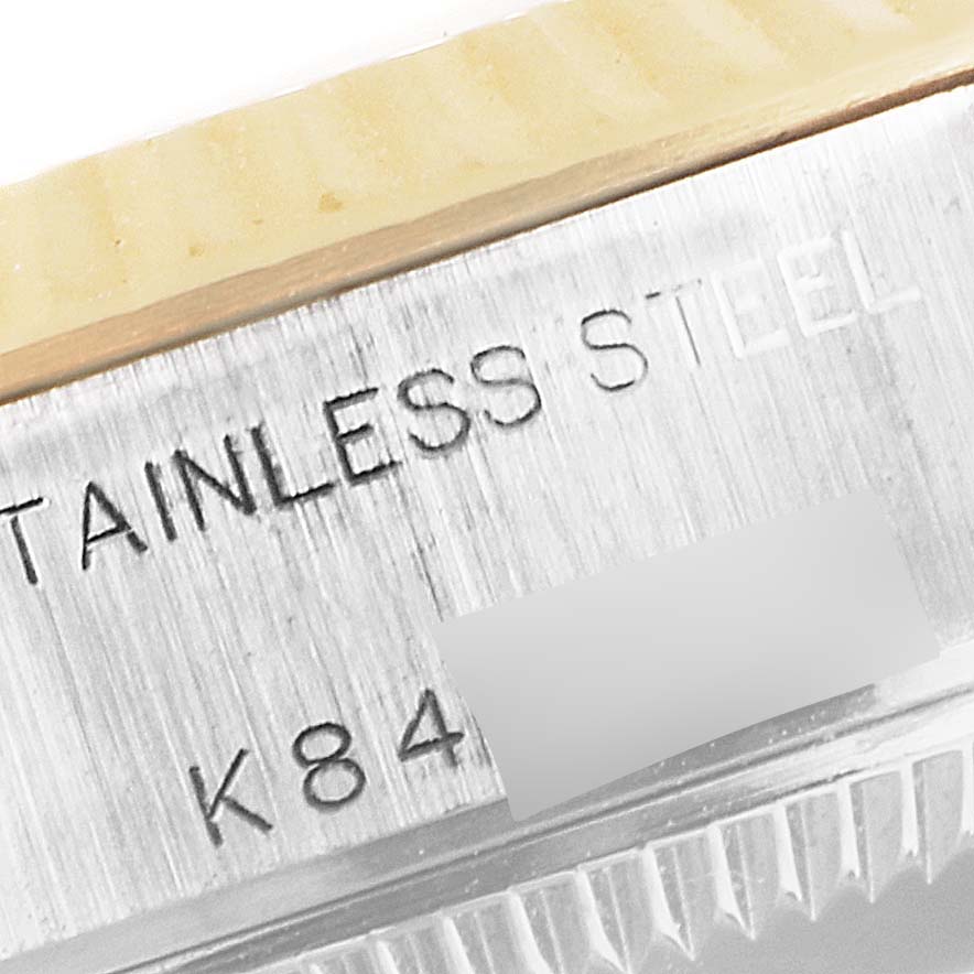 The image shows a close-up of the side case and bezel of a Rolex Datejust 79173 Women's Steel and Gold (two tone) Mother of Pearl Dial 79173 Women's Steel and Gold (two tone) Mother of Pearl Dial watch, highlighting its stainless steel material and serial number.