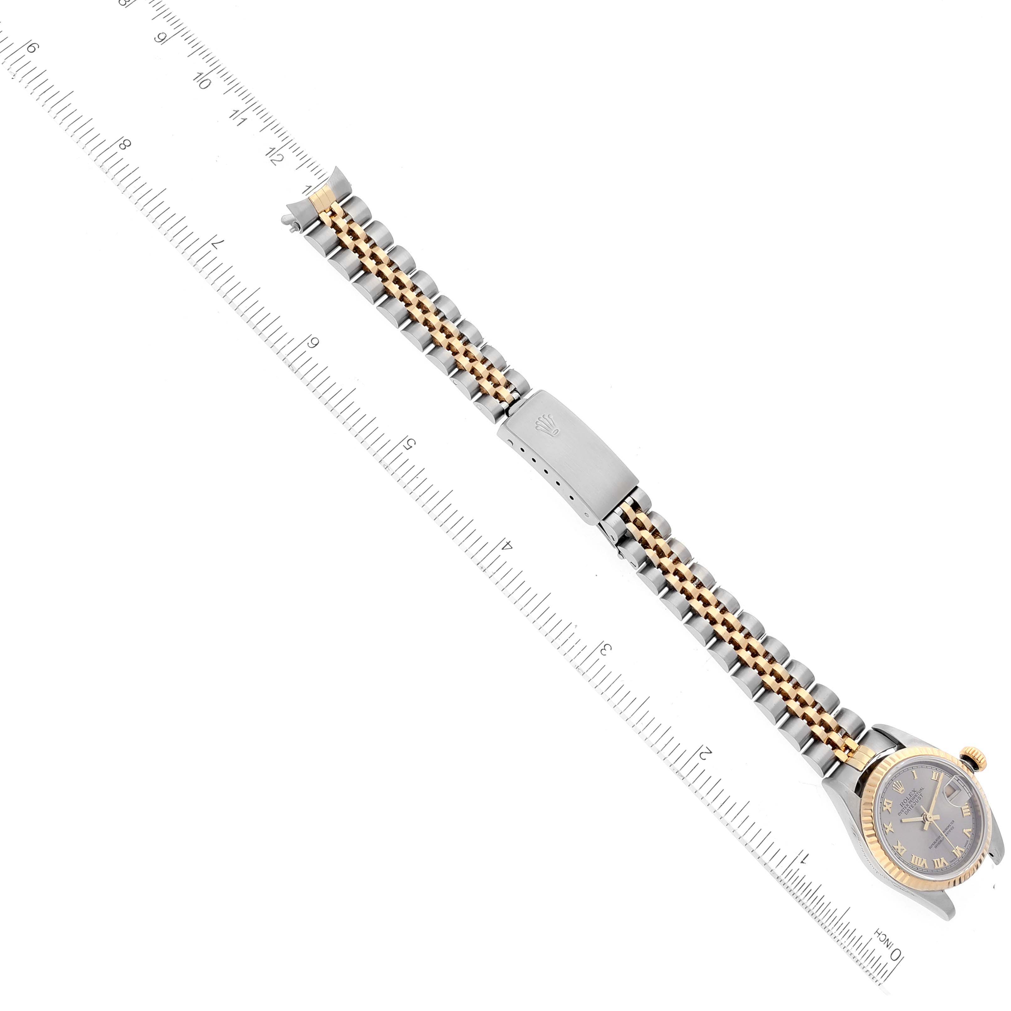 The Rolex Datejust 79173 Women's Steel and Gold (two tone) Grey Dial 79173 Women's Steel and Gold (two tone) Grey Dial watch is shown from a top-down angle, highlighting the face, bracelet, and clasp.