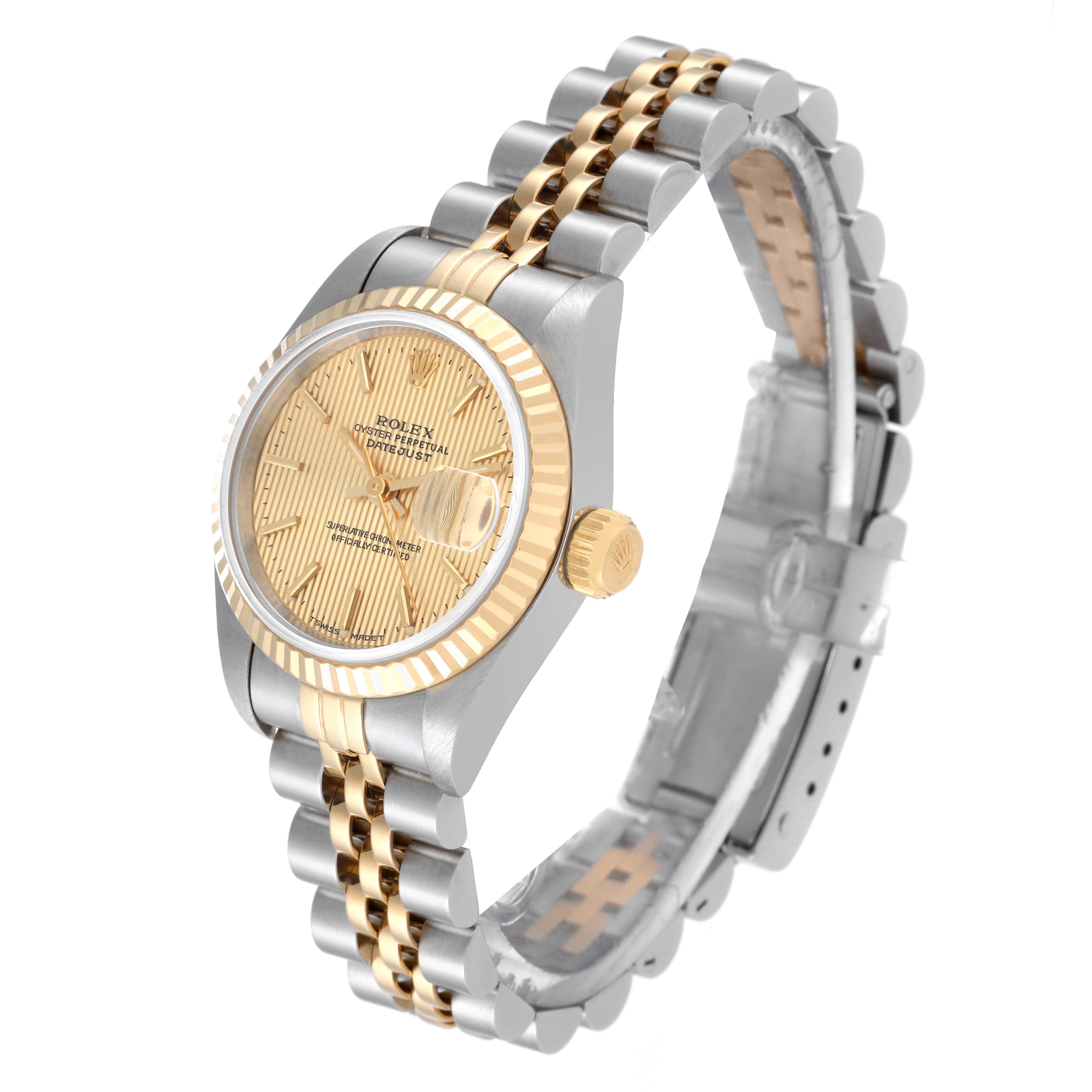 The image shows a side angle of the Rolex Datejust 69173 Women's Steel and Gold (two tone) Champagne Dial 69173 Women's Steel and Gold (two tone) Champagne Dial watch, highlighting its gold and silver case, bracelet, and fluted bezel.