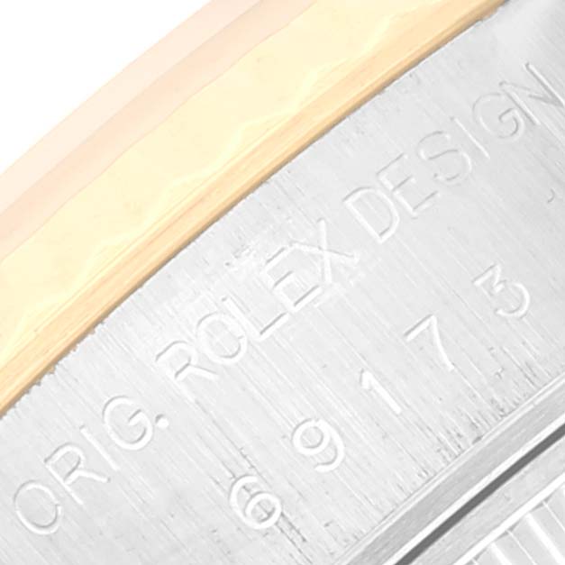 This image shows a close-up of the engraved outer edge of a Rolex Datejust 69173 Women's Steel and Gold (two tone) Champagne Dial 69173 Women's Steel and Gold (two tone) Champagne Dial watch case.