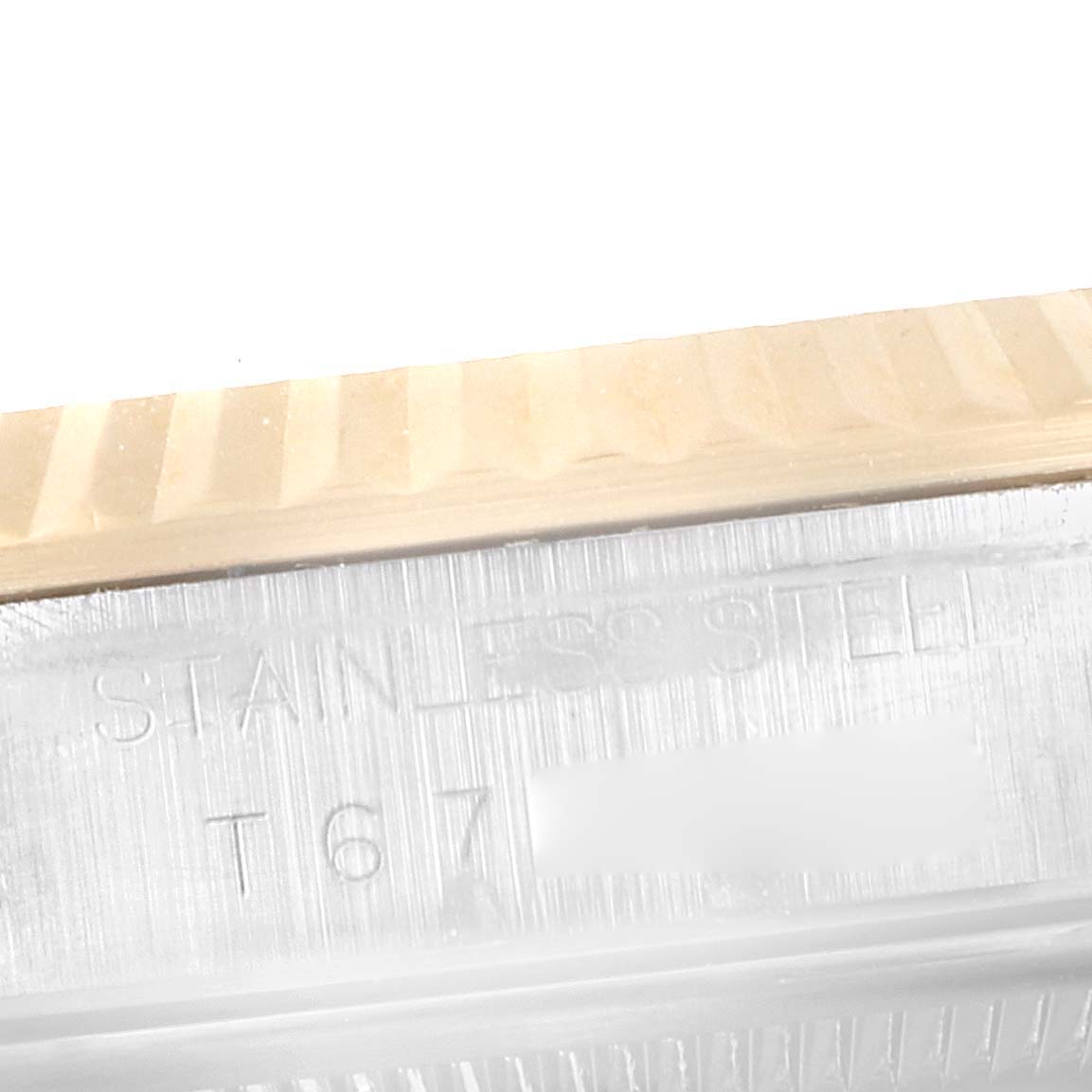 The image shows a close-up angle of the serial number and stainless steel inscription on the bezel of a Rolex Datejust 16233 Men's Steel and Gold (two tone) White Dial 16233 Men's Steel and Gold (two tone) White Dial watch.