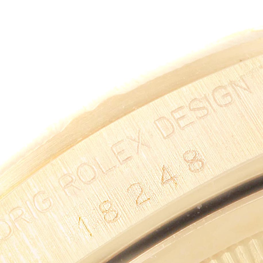 Close-up of the side of a Rolex President 18248 Men's Yellow Gold Silver Dial 18248 Men's Yellow Gold Silver Dial watch, showing the engraved model number "18248" and "Rolex Design."