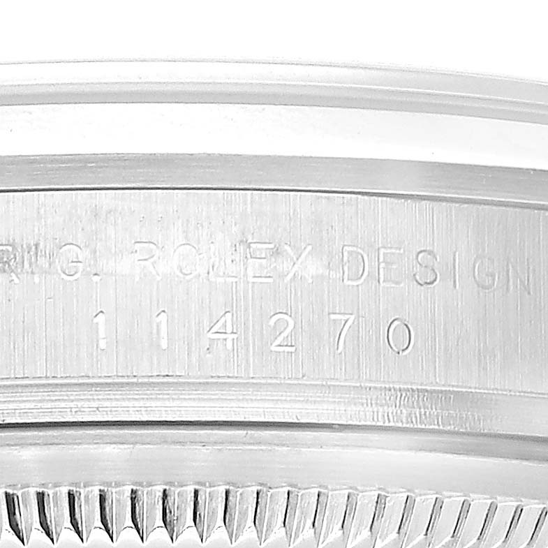 This image shows an angled close-up of the side of a Rolex Explorer 114270 Men's Stainless Steel Black Dial 114270 Men's Stainless Steel Black Dial watch, highlighting its model number and part of the bezel.