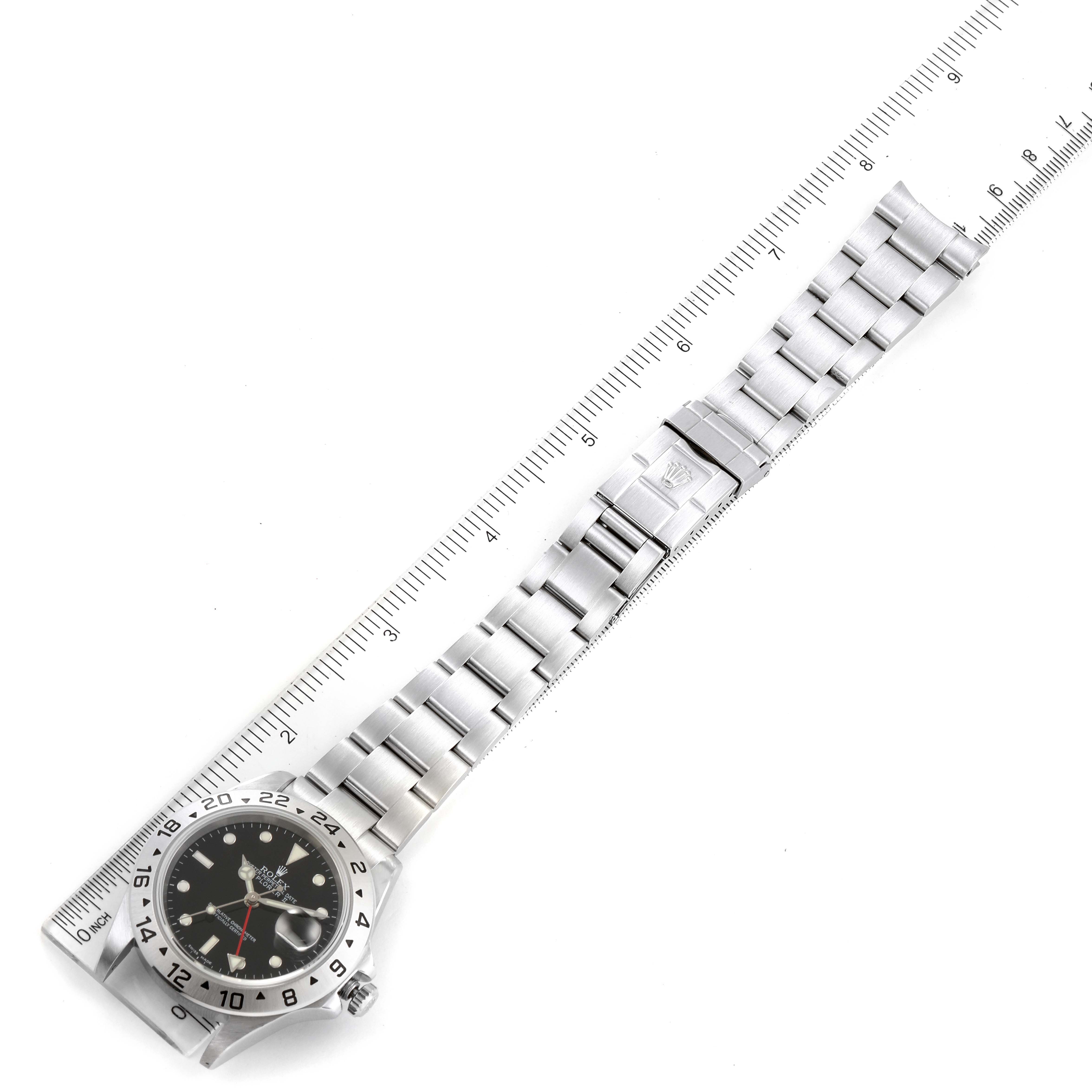 The image shows the face and full bracelet of a Rolex Explorer 16570 Men
s Stainless Steel Black Dial 16570 Men
s Stainless Steel Black Dial watch, laid flat beside a ruler for measurement.