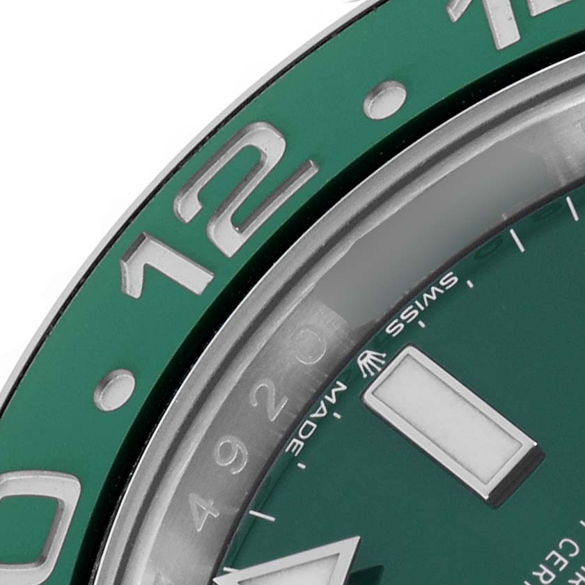 The image shows a close-up of the bezel and part of the dial of a Rolex GMT-Master 126729VTNR Men's White Gold Green Dial, highlighting the green color and markers.