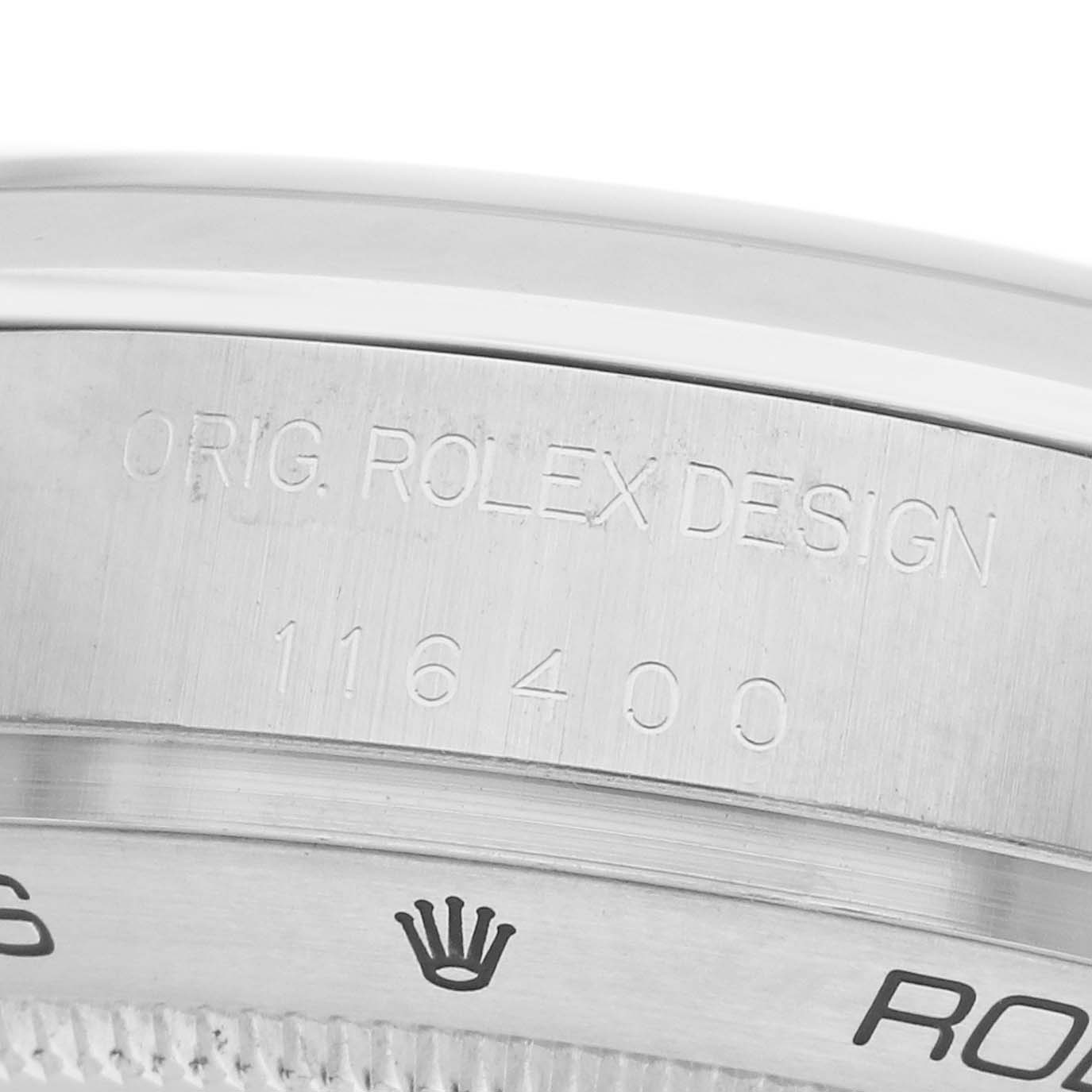 The image shows a close-up of the bezel and engraving on a Rolex Milgauss 116400 Men's Stainless Steel White Dial watch.