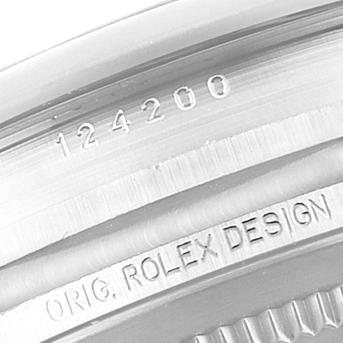 The image shows a close-up of the inner bezel of a Rolex Oyster Perpetual 124200 Men's Stainless Steel Silver Dial 124200 Men's Stainless Steel Silver Dial watch, displaying the model number and "ORIG. ROLEX DESIGN" engraving.