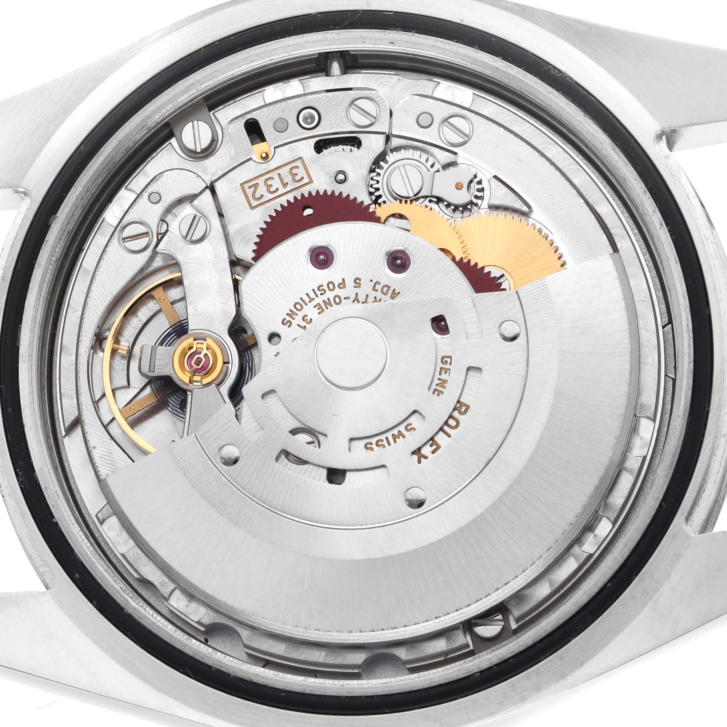 The image shows a detailed view of the movement of a Rolex Oyster Perpetual 114300 Men's Stainless Steel Black Dial watch, highlighting gears and components.