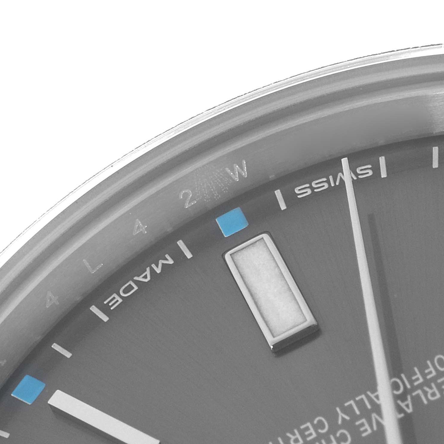 The image shows a close-up of a Rolex Oyster Perpetual 114300 Men's Stainless Steel Silver Dial watch face, highlighting the indices and “SWISS MADE” text.