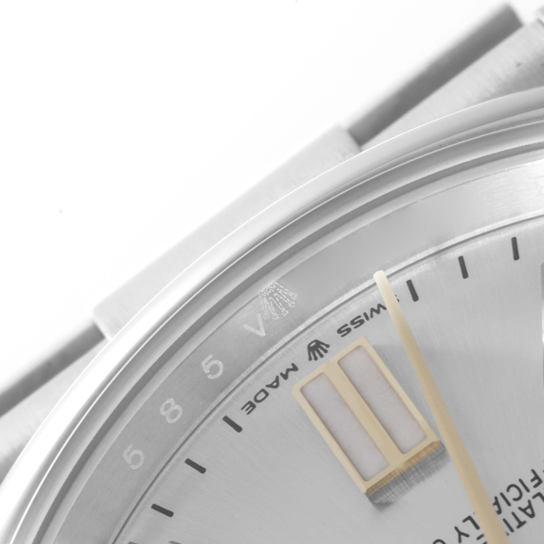 The image shows a close-up of the dial and bezel of a Rolex Oyster Perpetual 124300 Men's Stainless Steel Silver Dial 124300 Men's Stainless Steel Silver Dial watch, highlighting part of the minute hand and hour markers.