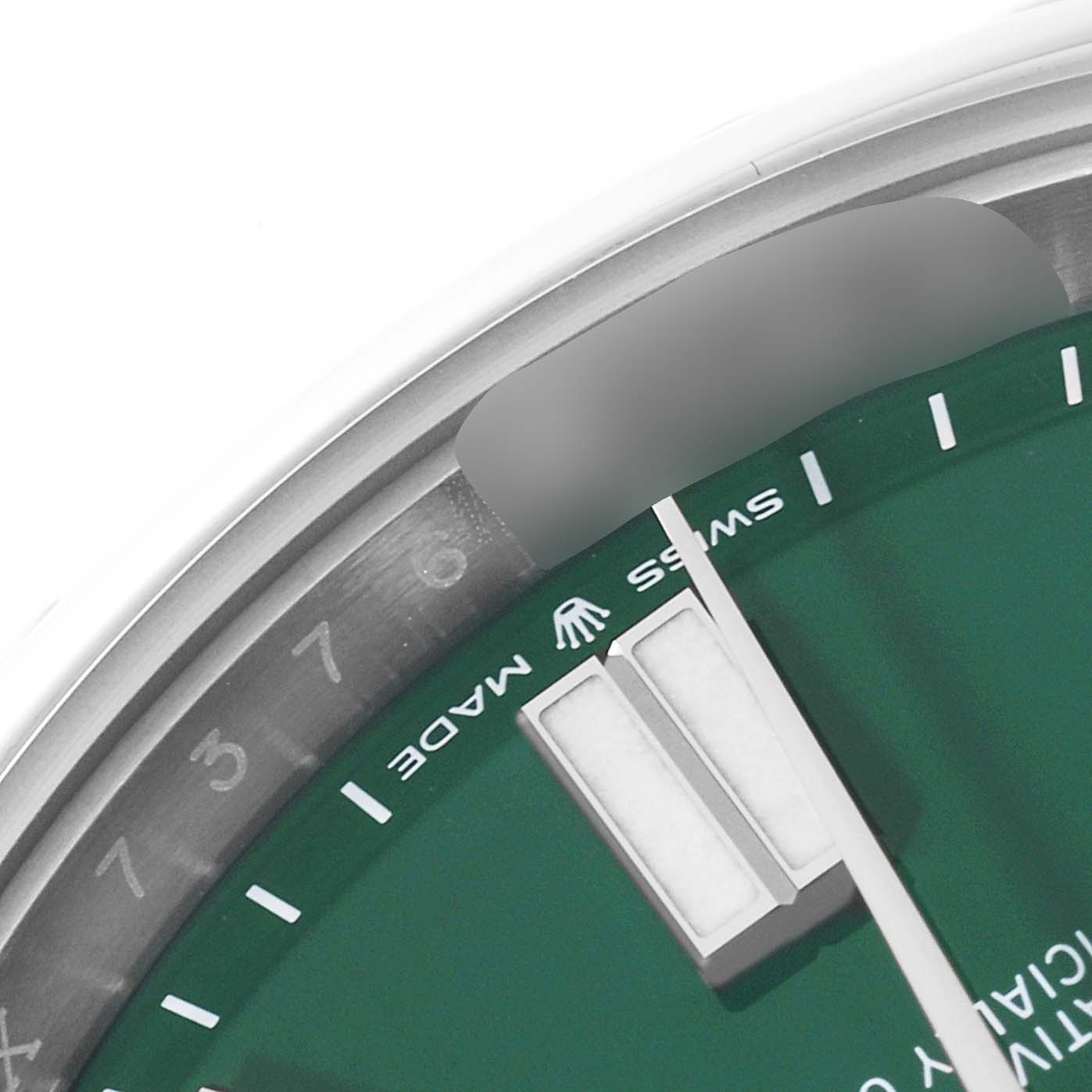 The image shows a close-up of the Rolex Oyster Perpetual 124300 Men's Stainless Steel Green Dial 124300 Men's Stainless Steel Green Dial's green watch dial, revealing the "Swiss Made" text and hour markers.