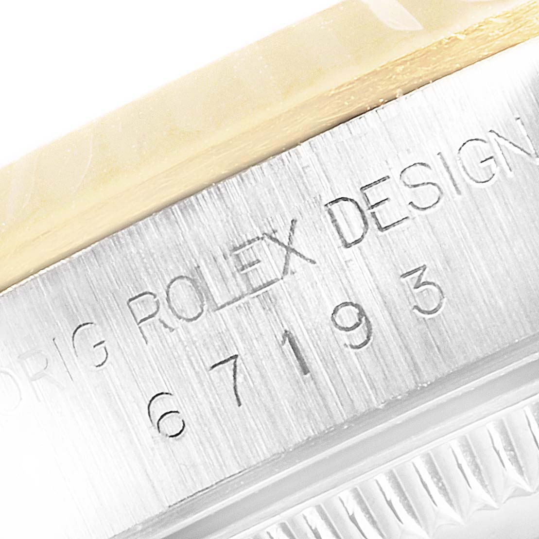 The image shows a close-up of the casing and serial number of a Rolex Oyster Perpetual 67193 Women
s Steel and Gold (two tone) Black Dial 67193 Women
s Steel and Gold (two tone) Black Dial watch.