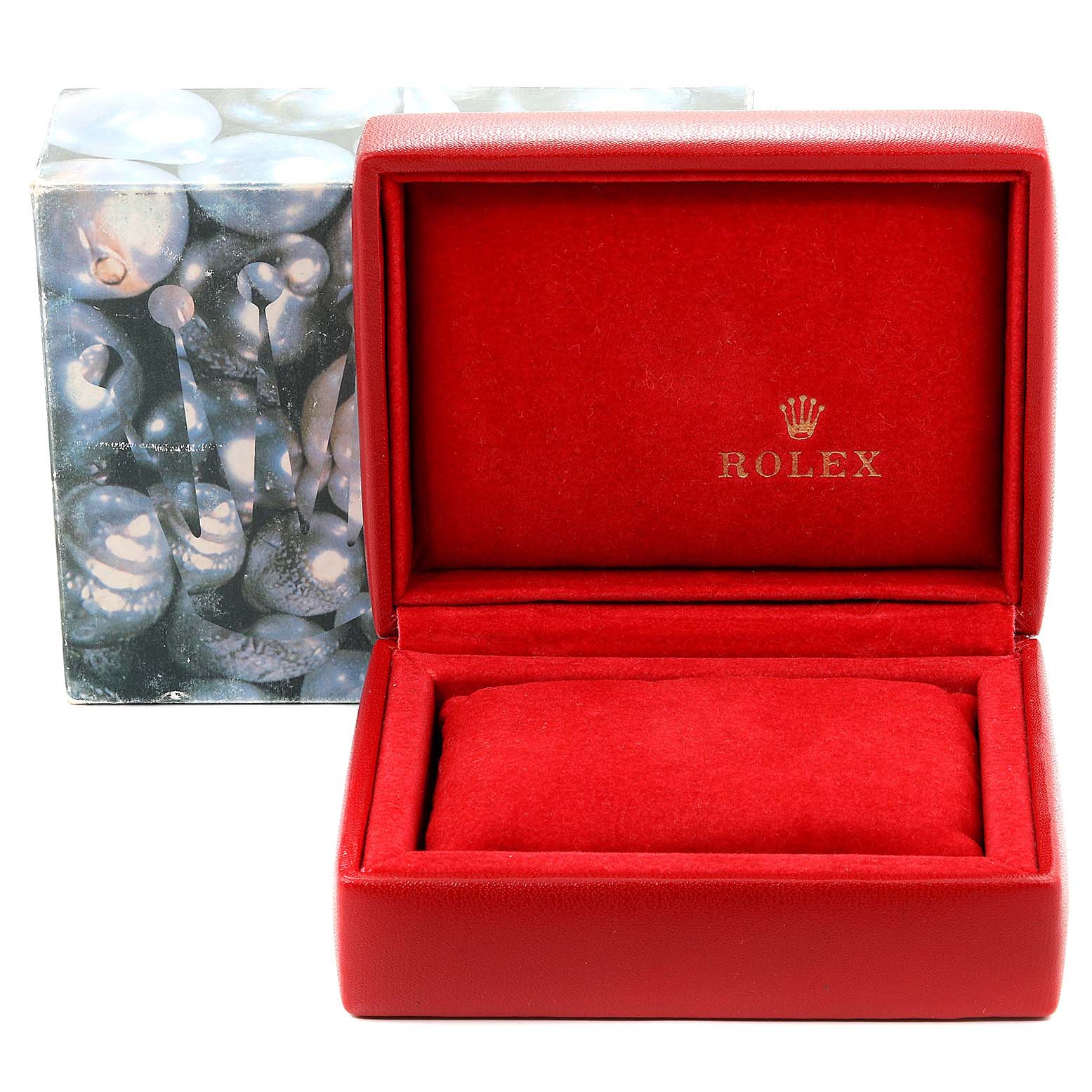 The image shows an open red Rolex box for the Oyster Perpetual model, displaying the interior cushion and the brand logo.