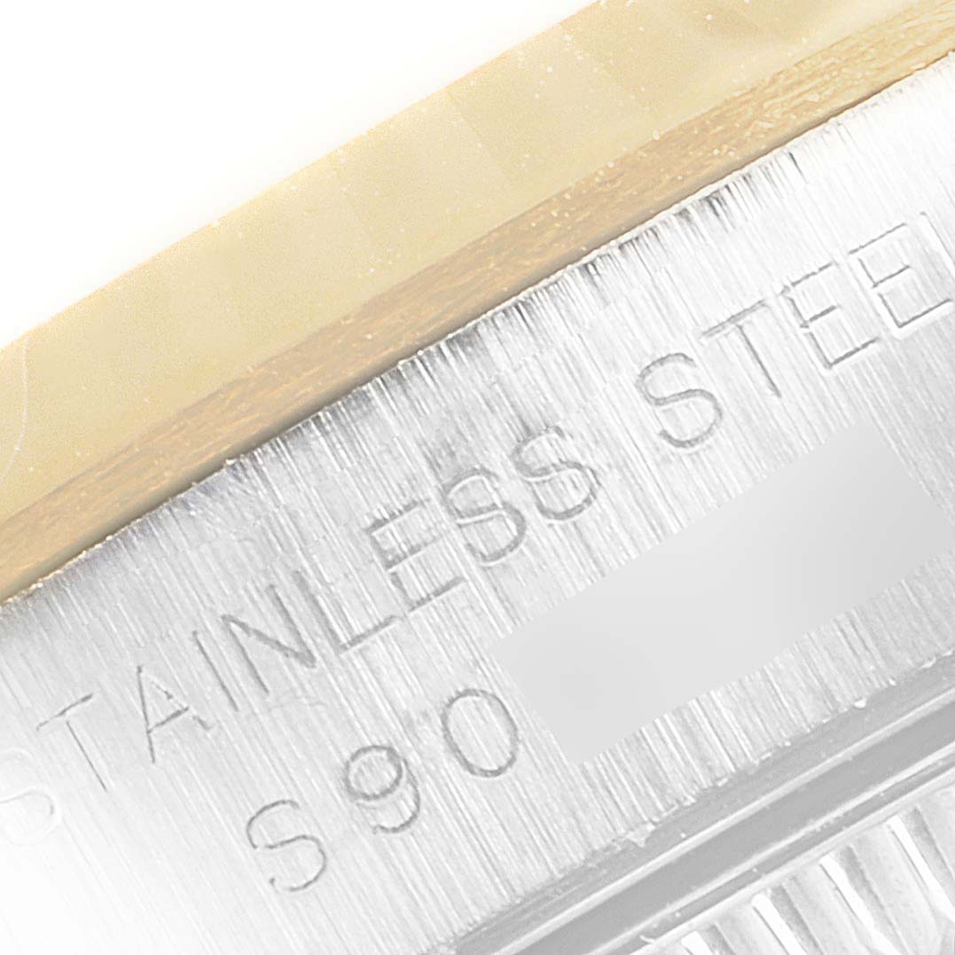 The image shows a close-up of the case back edge with the "STAINLESS STEEL" inscription of a Rolex Oyster Perpetual 67193 Women
s Steel and Gold (two tone) Black Dial 67193 Women
s Steel and Gold (two tone) Black Dial watch.