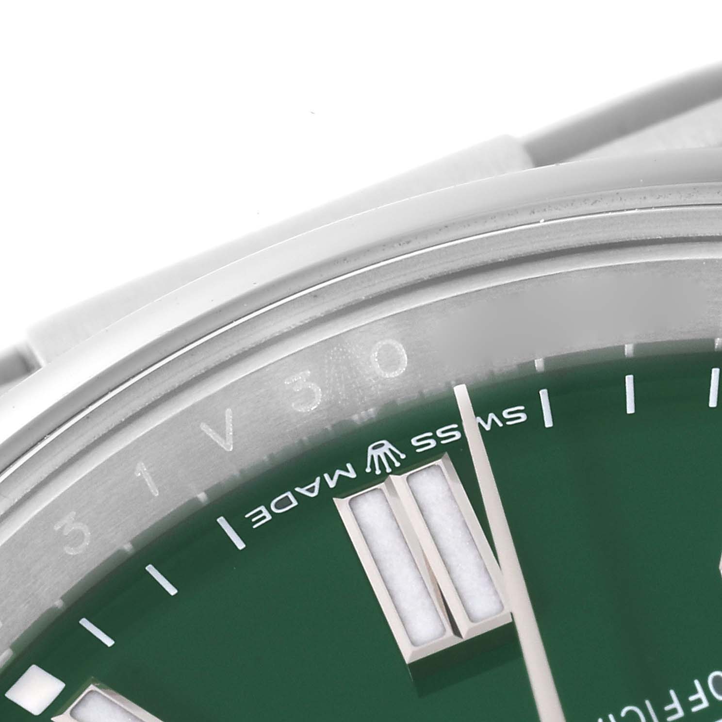 This close-up image shows part of the dial and bezel of a Rolex Oyster Perpetual 126000 Men's Stainless Steel Green Dial 126000 Men's Stainless Steel Green Dial watch, with "Swiss Made" and the Rolex logo visible.