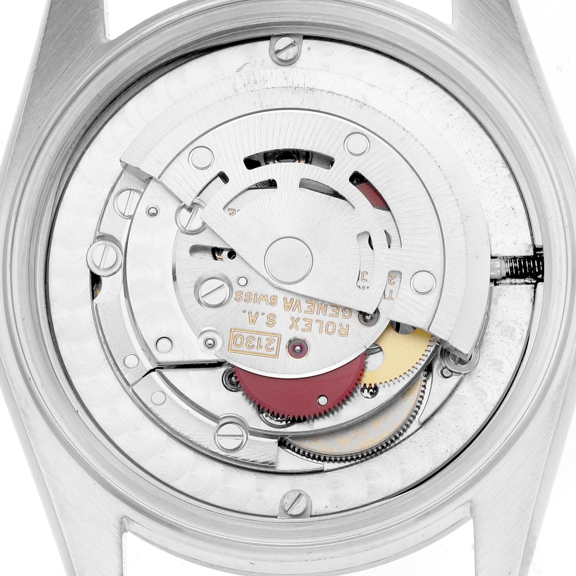The image shows the movement of a Rolex Mid-Size 67480 Women
s Stainless Steel Black Dial model from the back, detailing the internal mechanics.