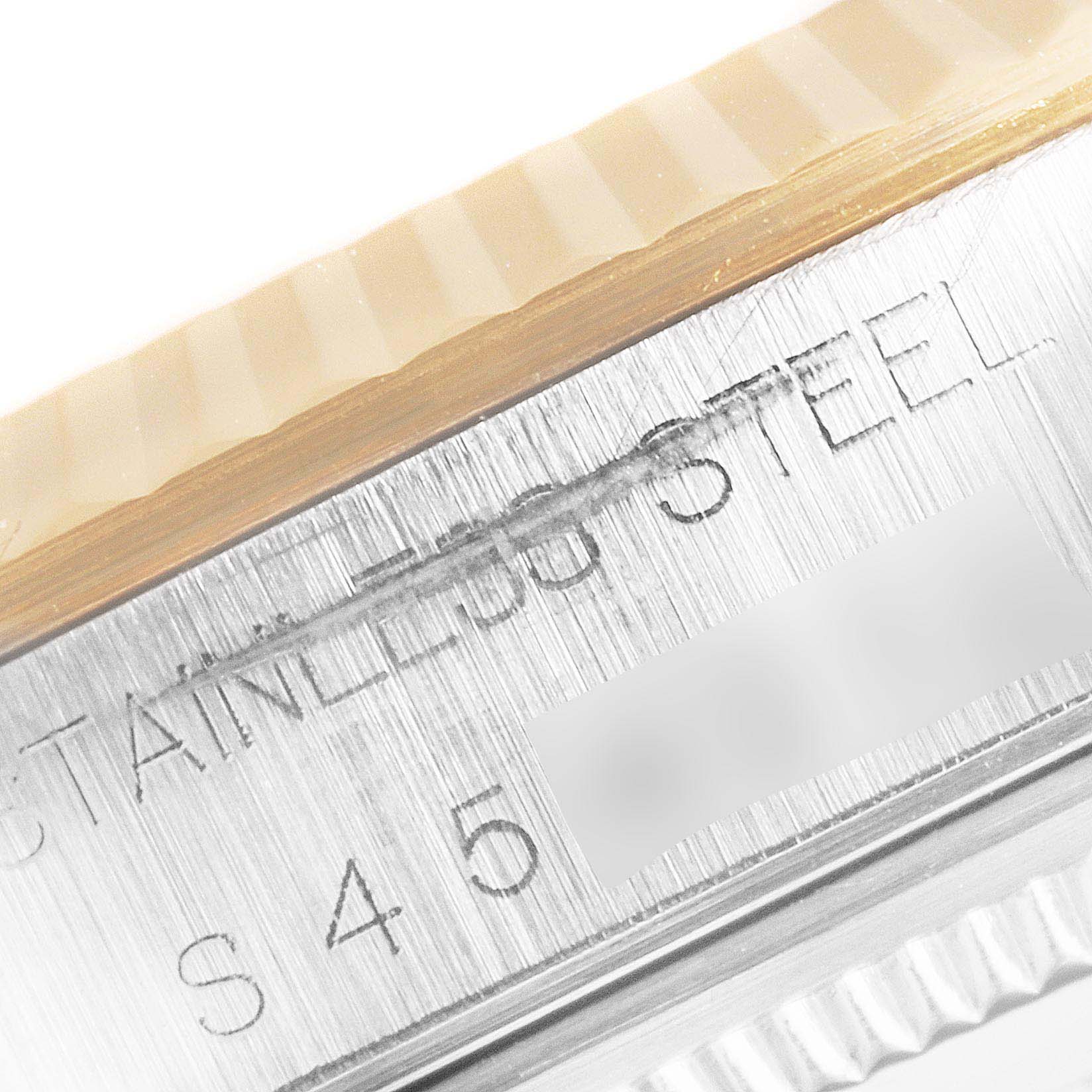 This image shows a close-up of the side case and part of the fluted bezel of a Rolex Oyster Perpetual 14233 Men's Steel and Gold (two tone) Champagne Dial 14233 Men's Steel and Gold (two tone) Champagne Dial watch.