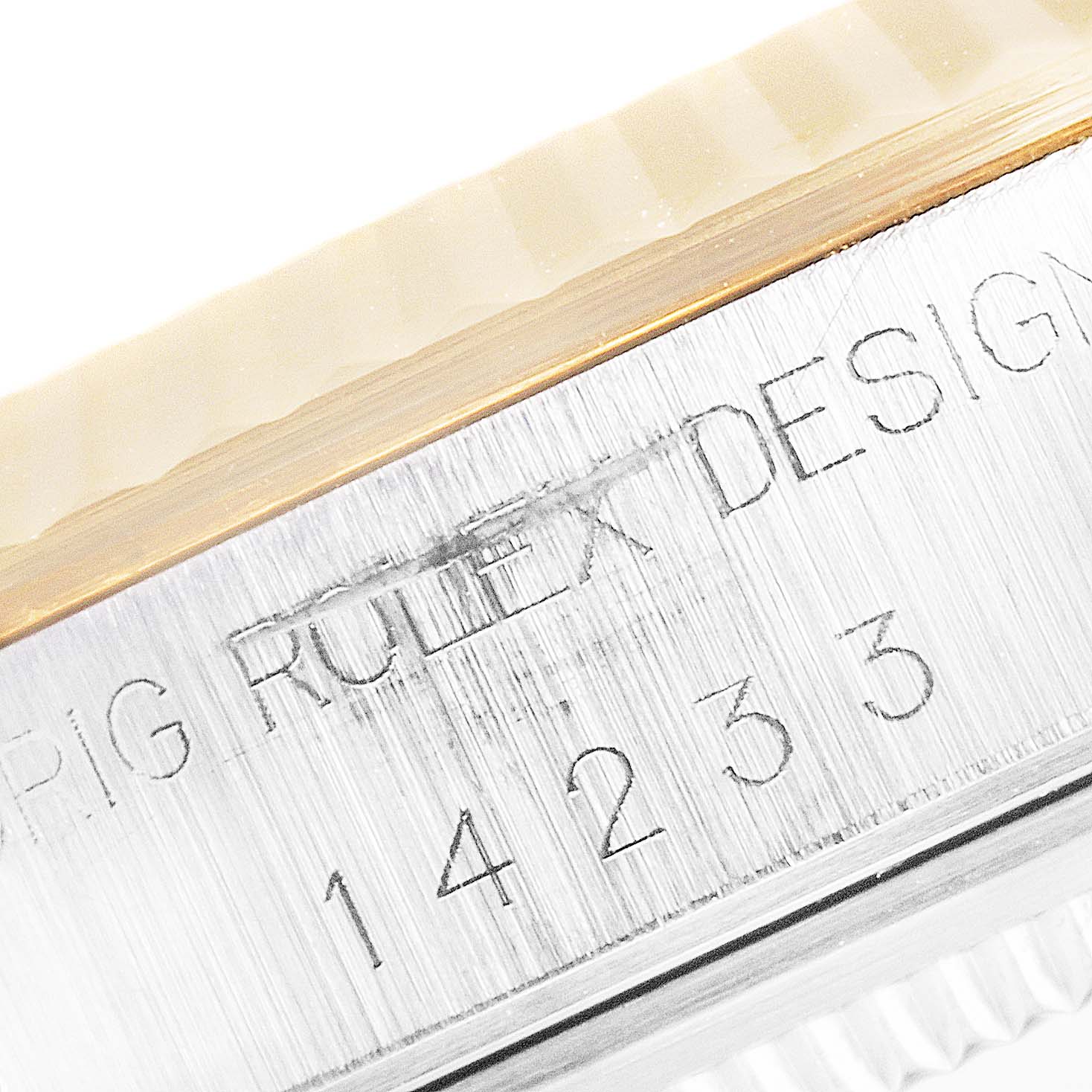 This image shows a close-up of the side engraving and the bezel of a Rolex Oyster Perpetual 14233 Men's Steel and Gold (two tone) Champagne Dial 14233 Men's Steel and Gold (two tone) Champagne Dial watch, model number 14233.