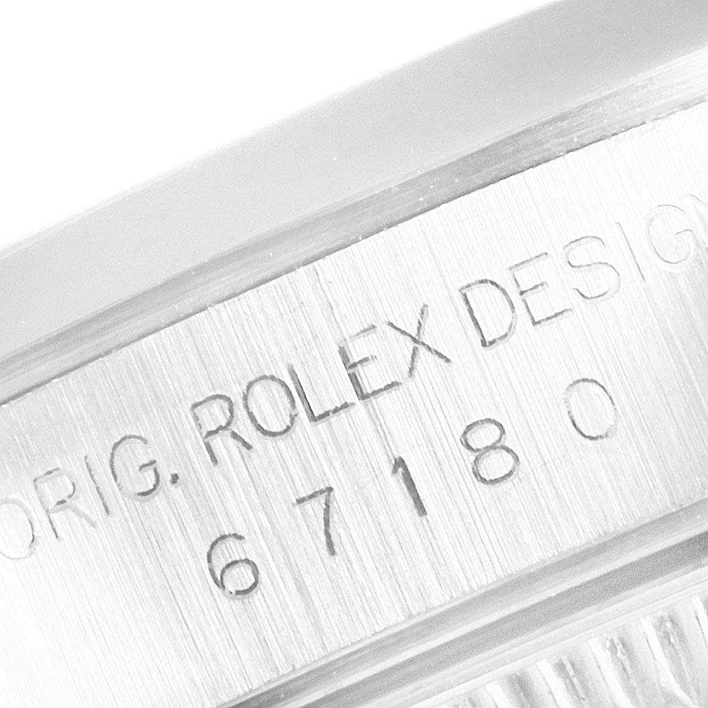 This image shows a close-up of the side casing with engraved text on a Rolex Oyster Perpetual 67180 Women's Stainless Steel White Dial 67180 Women's Stainless Steel White Dial watch.
