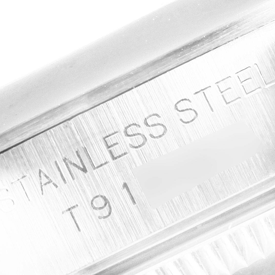 The image shows a close-up angle of the stainless steel casing with engraving on a Rolex Oyster Perpetual 67180 Women's Stainless Steel White Dial 67180 Women's Stainless Steel White Dial watch.