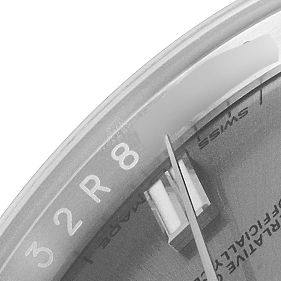 This image shows a close-up of the dial and minute hand of a Rolex Oyster Perpetual 116000 Men's Stainless Steel Grey Dial 116000 Men's Stainless Steel Grey Dial watch, with part of the "SWISS MADE" marking visible.