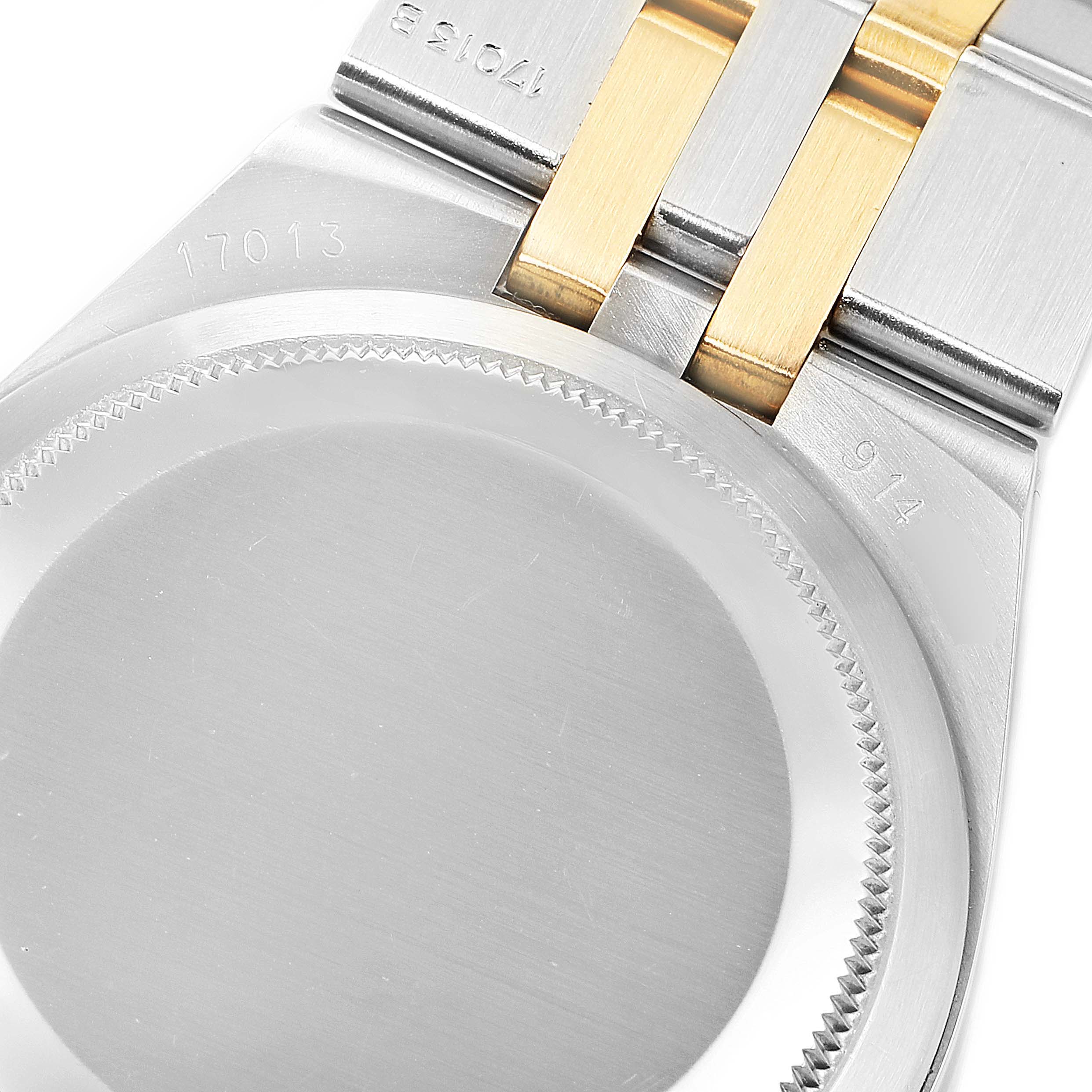 This image shows the back case and part of the bracelet of a Rolex Oysterquartz 17013 Men's Steel and Gold (two tone) Champagne Dial 17013 Men's Steel and Gold (two tone) Champagne Dial watch model 17013.