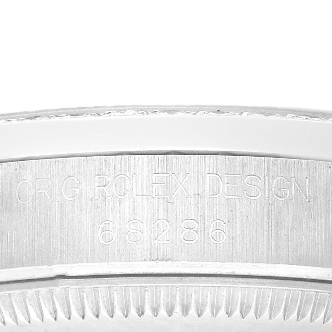 The image shows the edge of the Rolex President 68286 Women's Platinum Silver Dial model watch, highlighting the engraving on the side.