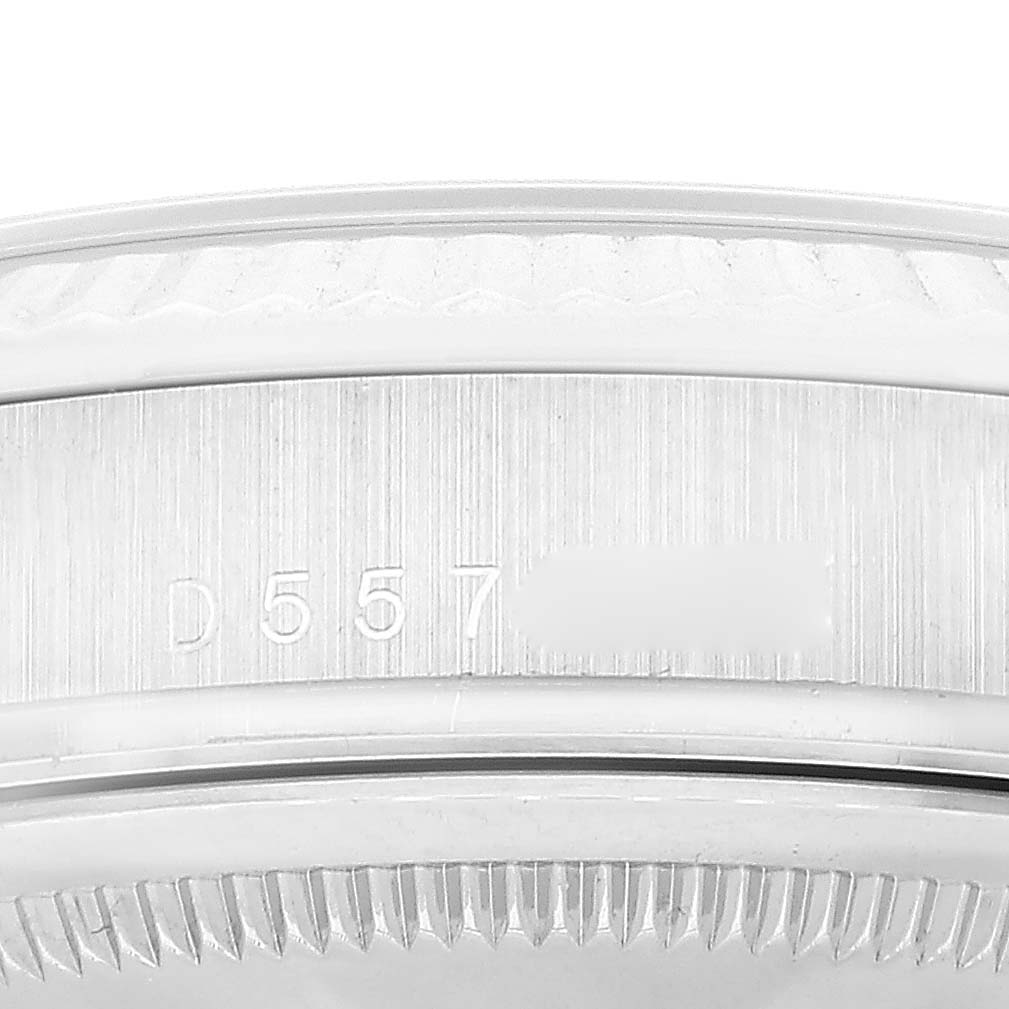 The image shows the brushed inner bezel and the outer part of the fluted bezel of a Rolex President 118239 Men's White Gold Silver Dial 118239 Men's White Gold Silver Dial model watch.