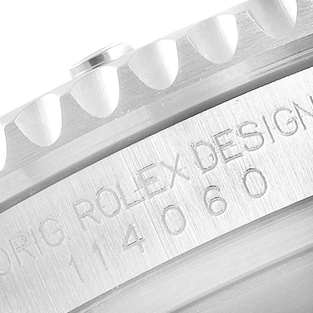 The image shows a close-up of the casing and serial number engraved on a Rolex Submariner 114060 Men's Stainless Steel Black Dial 114060 Men's Stainless Steel Black Dial watch.