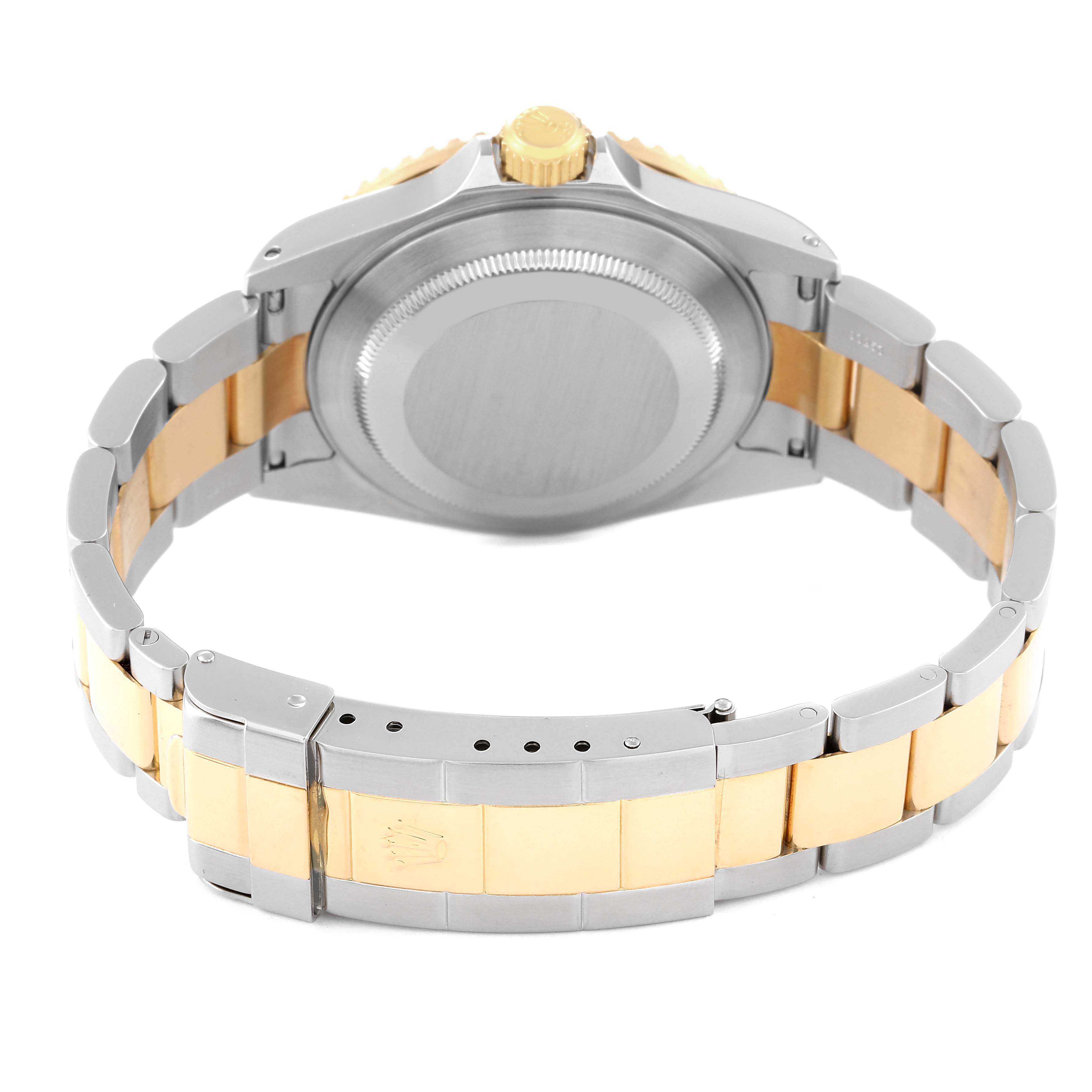 The image shows the back view of the Rolex Submariner 16613 Men's Steel and Gold (two tone) Blue Dial 16613 Men's Steel and Gold (two tone) Blue Dial watch, highlighting its case back, gold crown, and two-tone metal bracelet.