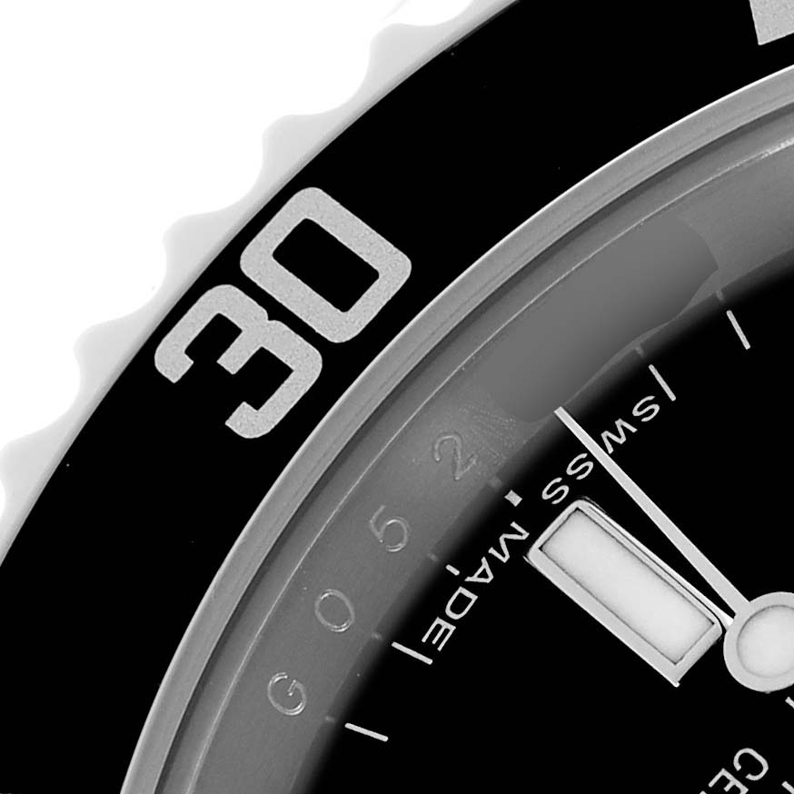 The image shows a close-up of the bezel and part of the dial of a Rolex Submariner 14060M Men's Stainless Steel Black Dial watch, highlighting the minute markers and indices.