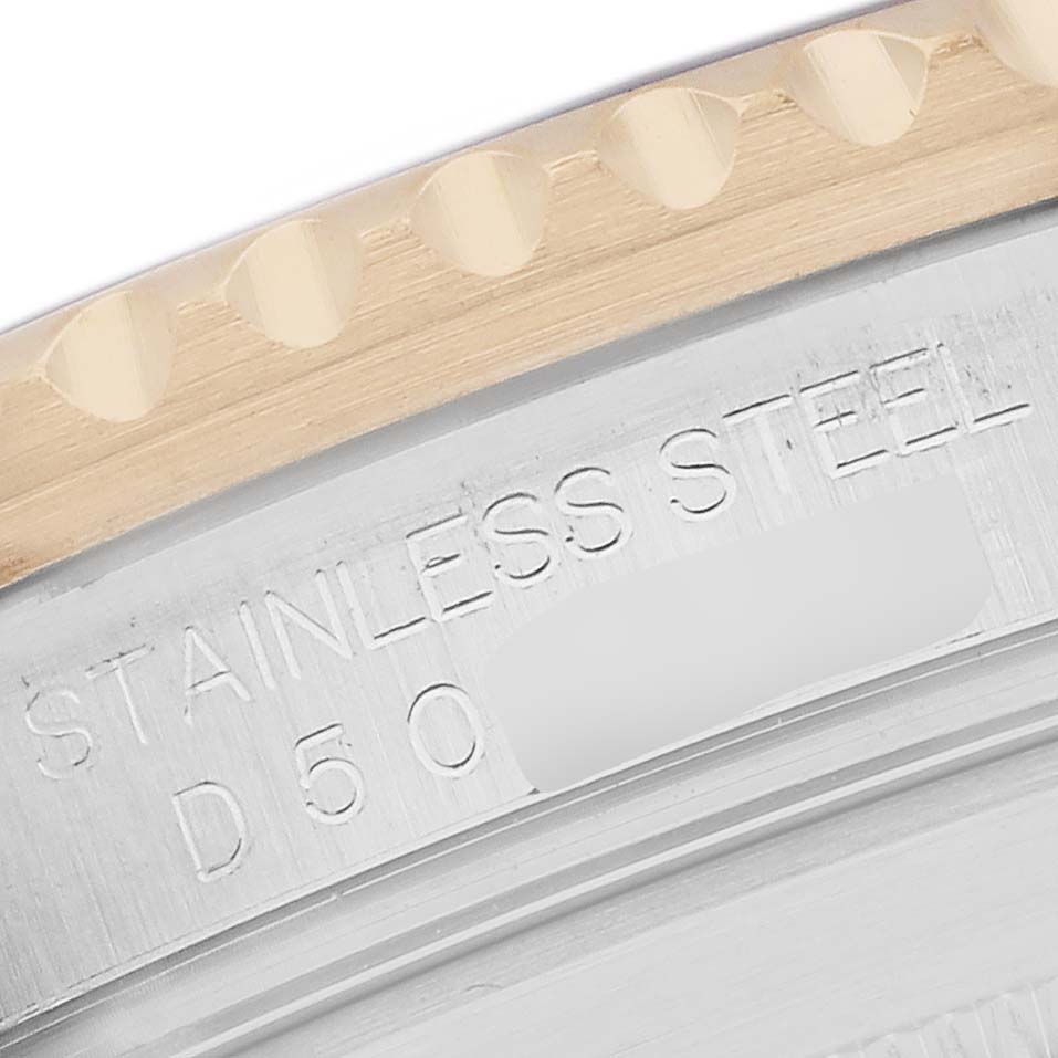 The image shows a close-up of the side and part of the bezel of a Rolex Submariner 16613 Men's Steel and Gold (two tone) Blue Dial, highlighting the "STAINLESS STEEL" engraving.