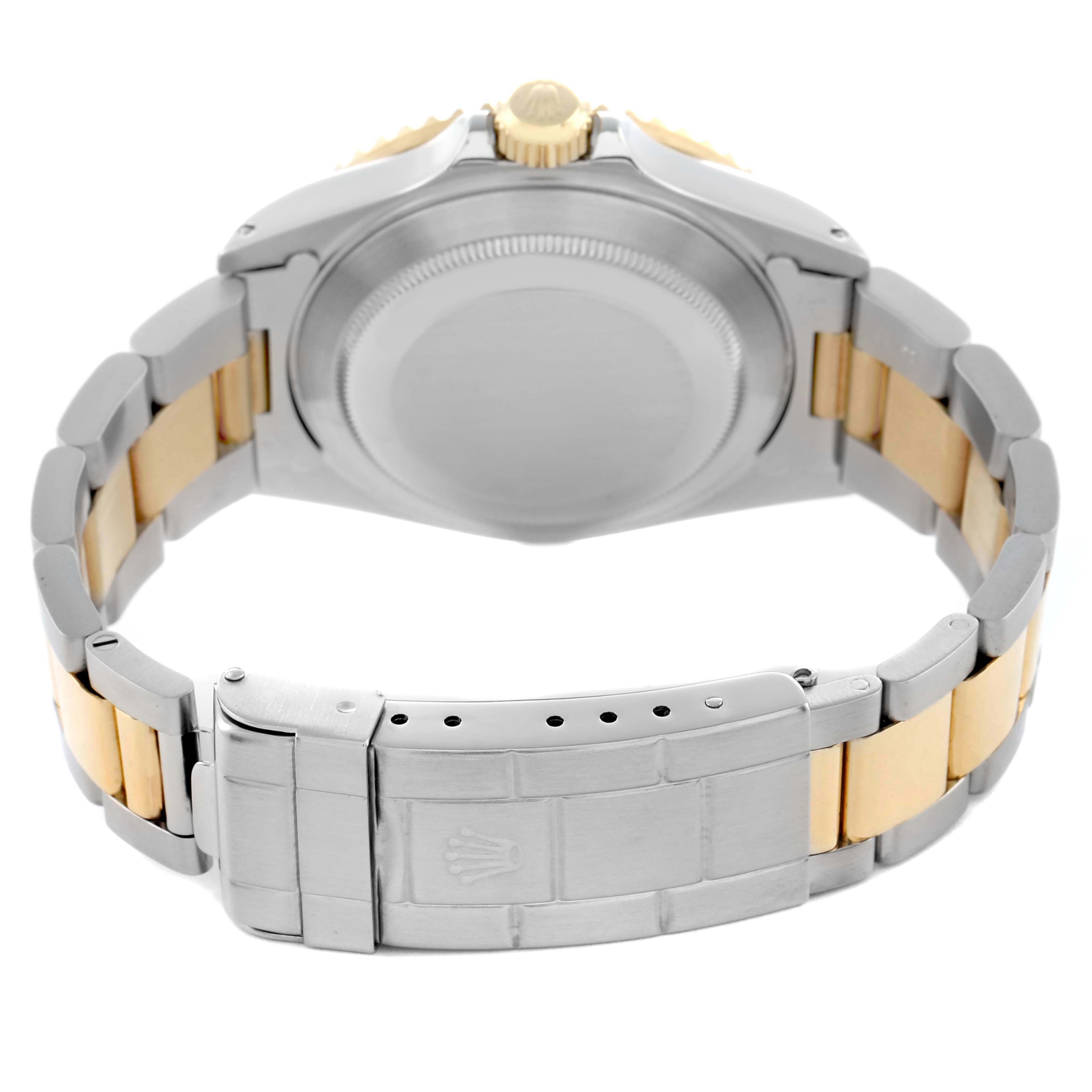 The image shows the back view of a Rolex Submariner 16613 Men's Steel and Gold (two tone) Champagne Dial, highlighting the clasp, case back, and two-tone bracelet.