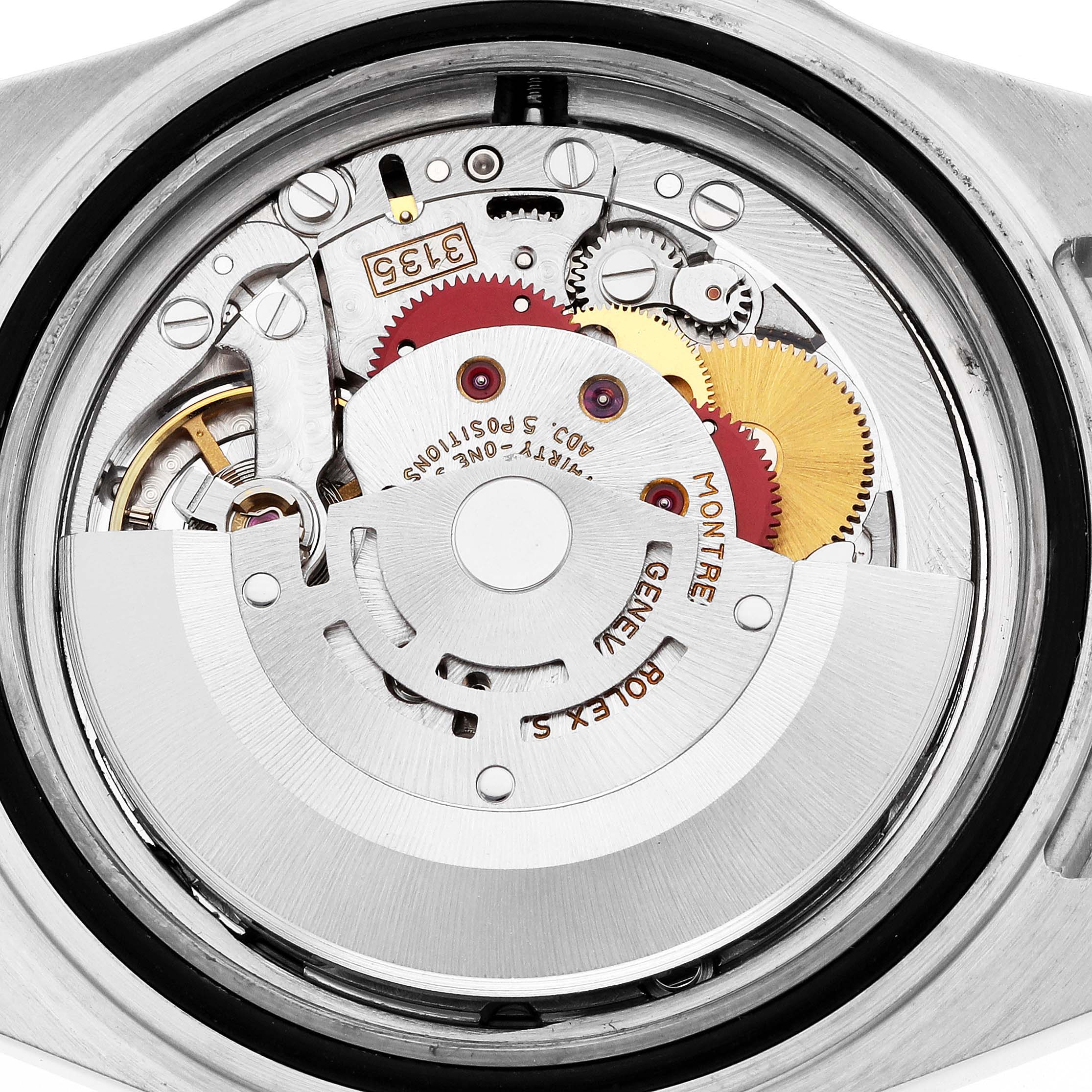 The image shows the internal mechanics of a Rolex Submariner 16613 Men's Steel and Gold (two tone) Champagne Dial watch from the back, highlighting its movement components.