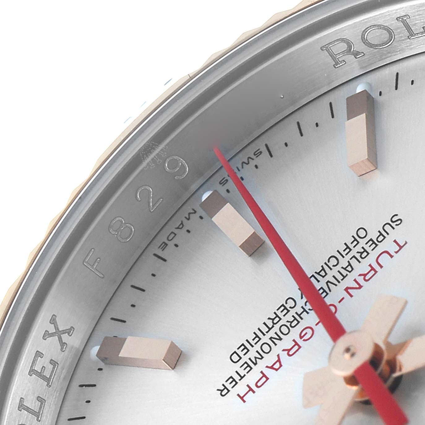 The image shows a close-up of the dial and bezel of the Rolex Turn-o-Graph 116261 Men's Steel and Gold (two tone) Silver Dial 116261 Men's Steel and Gold (two tone) Silver Dial watch, highlighting the hour markers and red second hand.