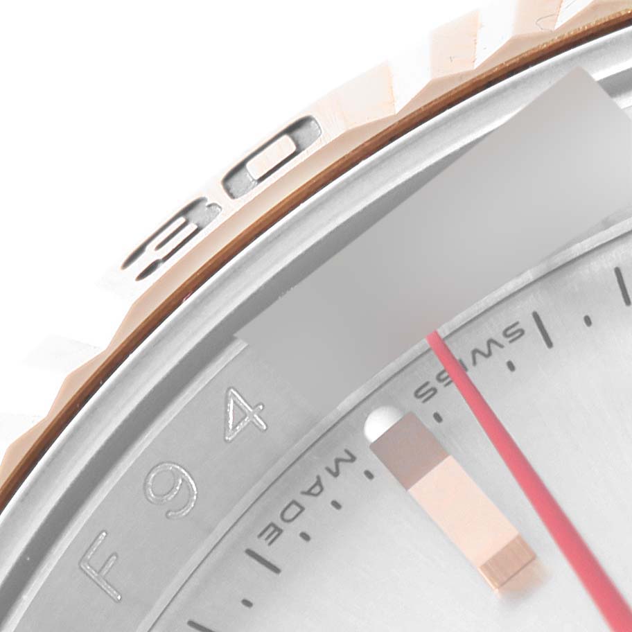 This image of the Rolex Turn-o-Graph 116261 Men's Steel and Gold (two tone) Silver Dial 116261 Men's Steel and Gold (two tone) Silver Dial model shows a close-up of the bezel and part of the dial, highlighting the numerals and markings.