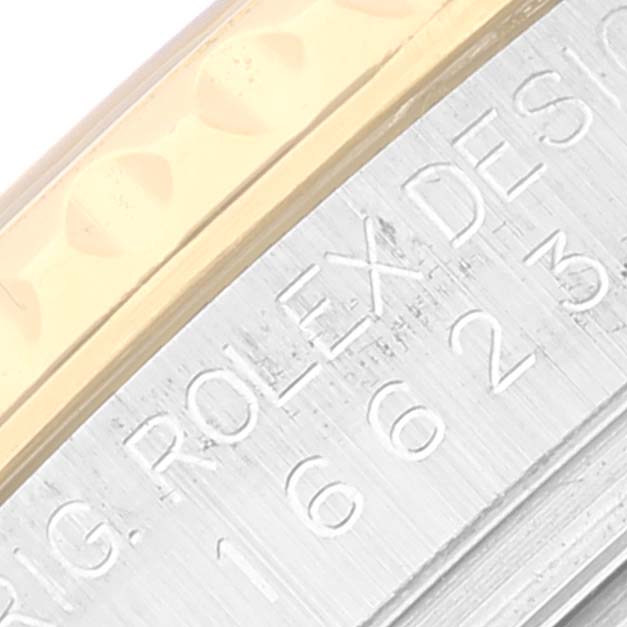 This close-up image of the Rolex Yacht-Master 16623 Men's Steel and Gold (two tone) Mother of Pearl Dial 16623 Men's Steel and Gold (two tone) Mother of Pearl Dial watch shows part of the bezel and engraved "Rolex Design" text on the side.