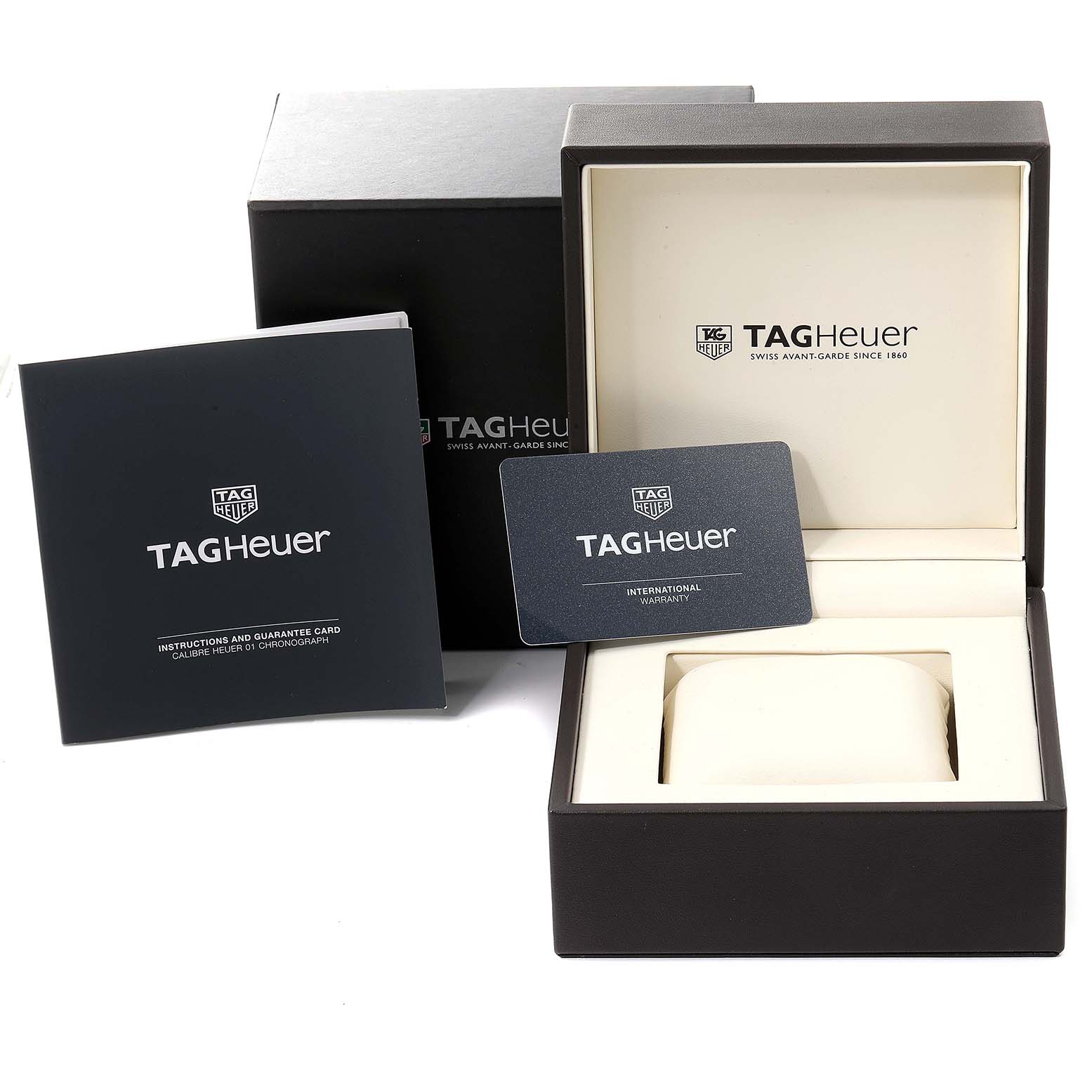 The image shows the packaging, warranty card, and manual for the Tag Heuer Carrera CAR201V.BA0714 Men
s Stainless Steel Black Dial CAR201V.BA0714 Men
s Stainless Steel Black Dial watch, with the box open.